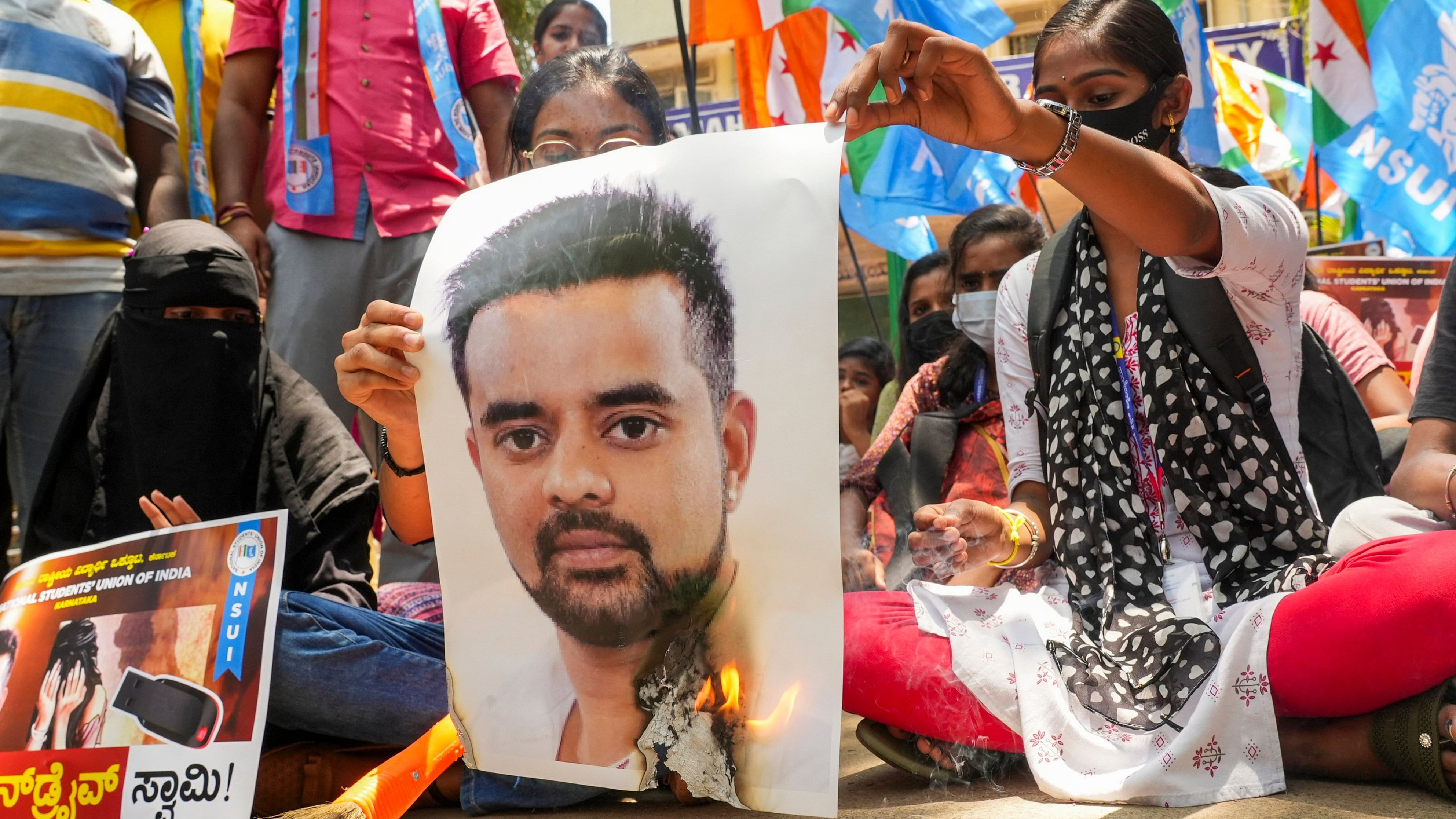 <div class="paragraphs"><p>Protesters burn a poster of JD(S) MP Prajwal Revanna during a protest against his involvement in the alleged sexual abuse case.</p></div>