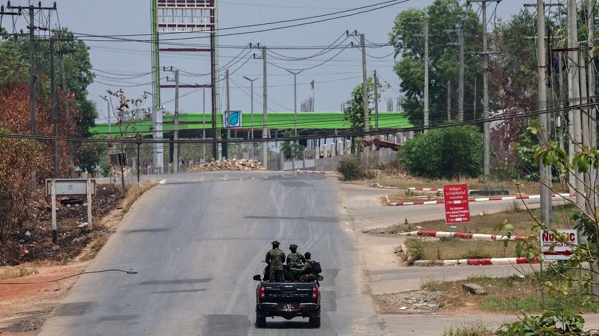 <div class="paragraphs"><p>Soldiers from the Karen National Liberation Army (KNLA) patrol on a vehicle, next to an area destroyed by Myanmar's airstrike in Myawaddy, the Thailand-Myanmar border town.</p></div>