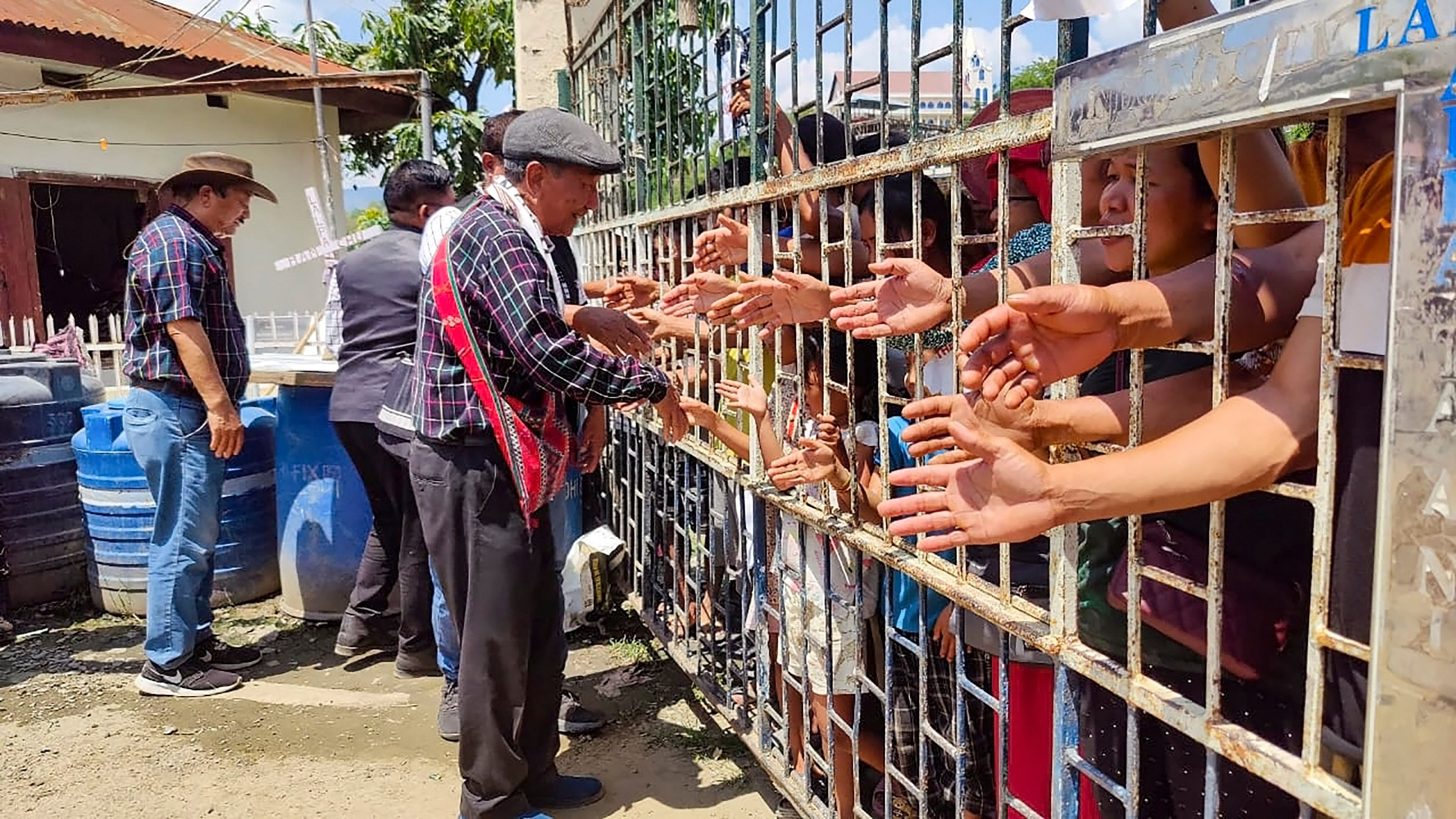 <div class="paragraphs"><p> Indian citizens shake hands with Myanmar nationals during a rally against scrapping of the Free Movement Regime (FMR), at Indo-Myanmar Friendship Gate, at Zokhawthar village along India-Myanmar border, in Champhai district of Mizoram, Thursday, May 16, 2024.</p></div>