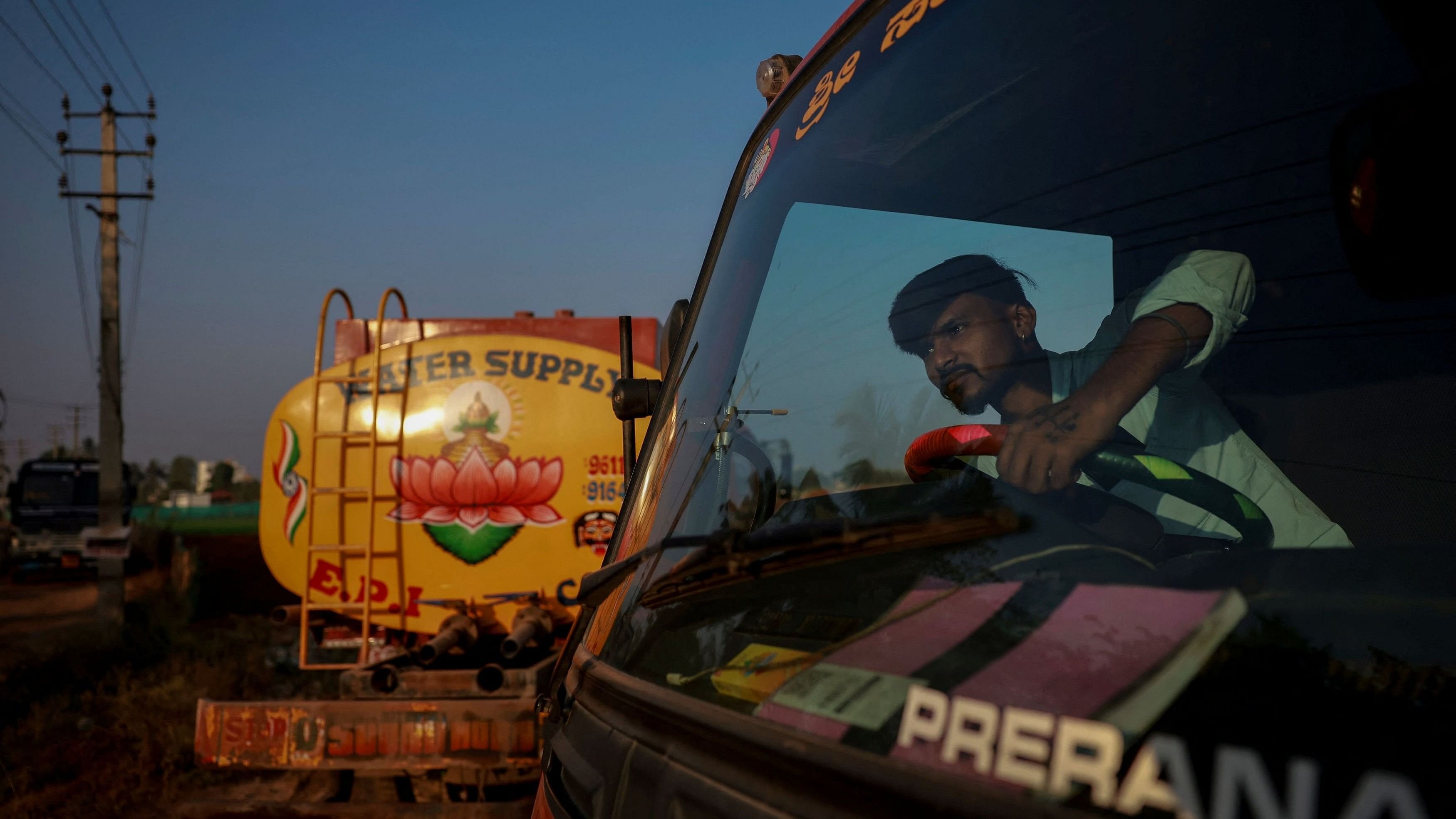 <div class="paragraphs"><p>Basavaraj, a water tanker driver, drives his truck as he heads off to deliver water to customers in Bengaluru.</p></div>