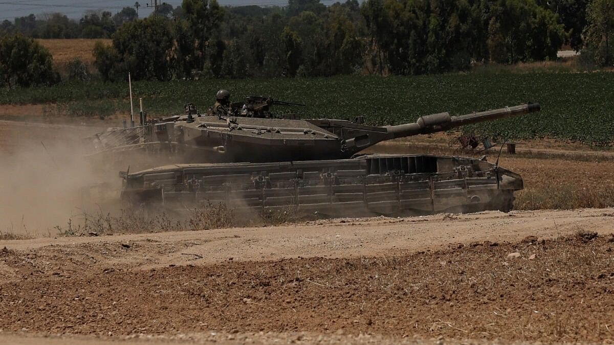 <div class="paragraphs"><p>An Israeli tank manoeuvres near the Israel-Gaza border, amid the ongoing conflict between Israel and the Palestinian Islamist group Hamas, in Israel.</p></div>