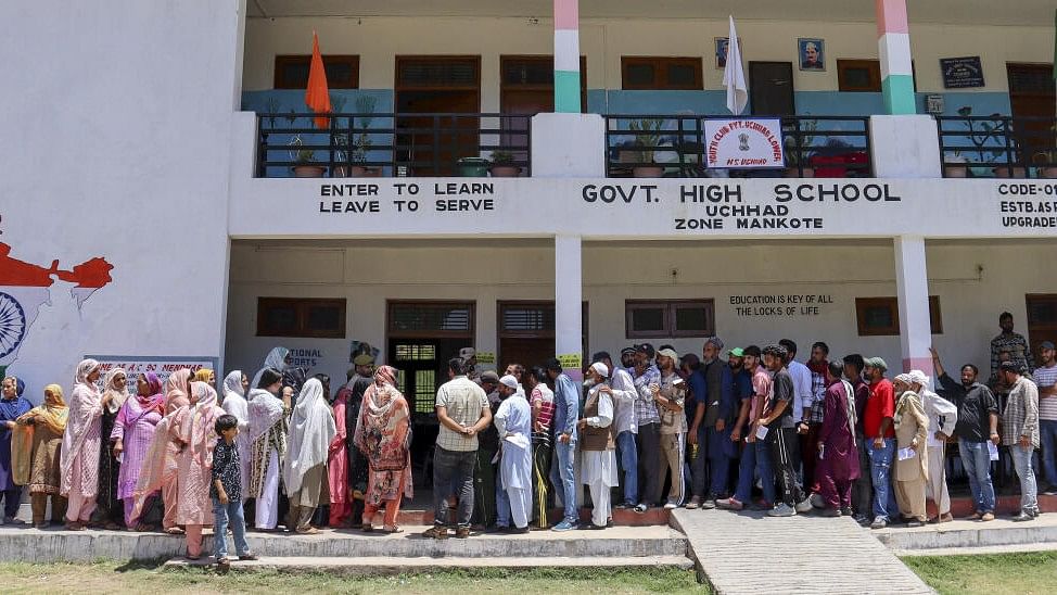 <div class="paragraphs"><p>People wait in queues at a polling station during sixth phase of Lok sabha elections in Kashmir.&nbsp;</p></div>