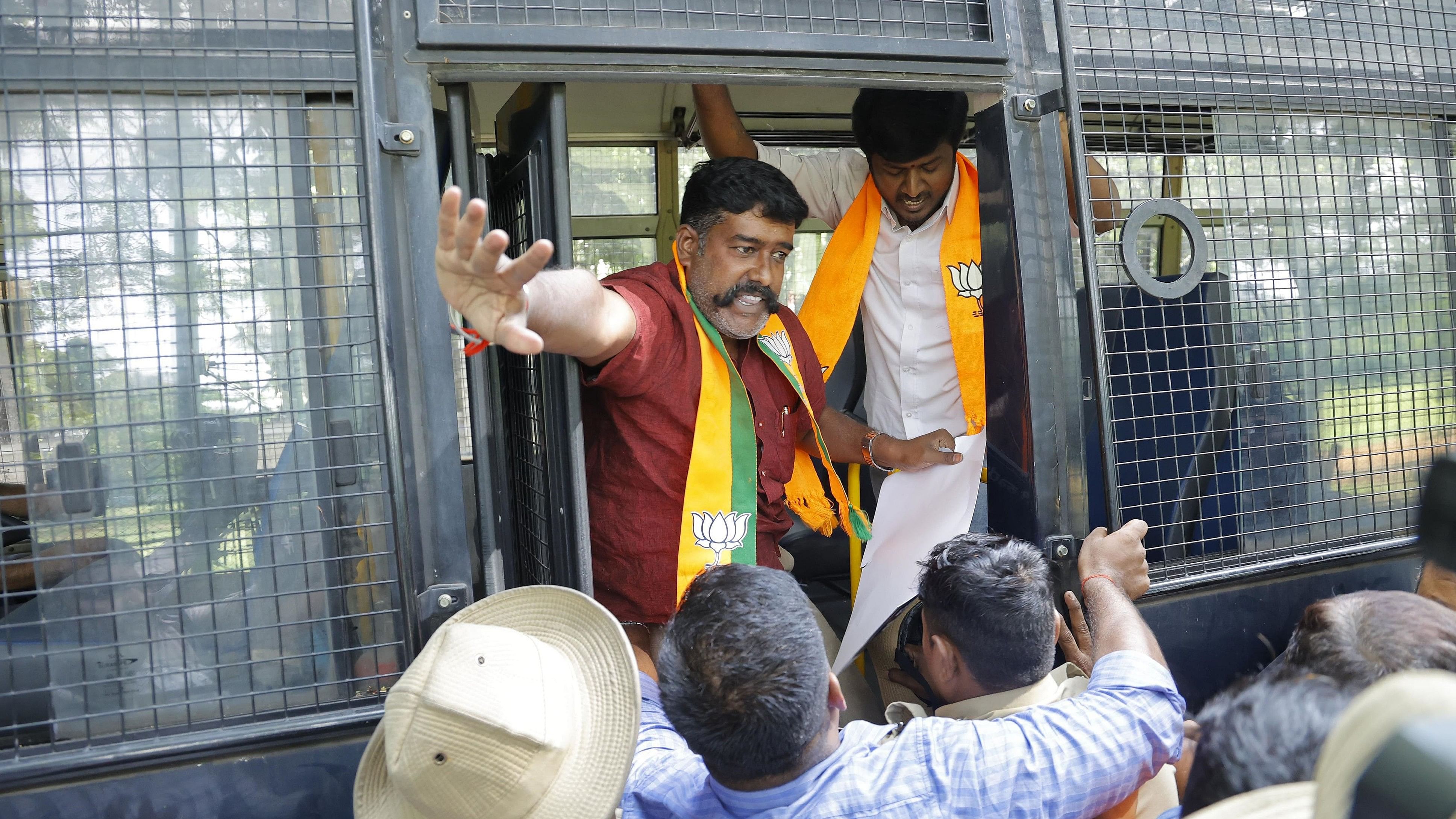 Police detain the members of BJP Scheduled Tribe Morcha after they attempted to lay a siege to the chief minister's residence, in Bengaluru on Thursday.