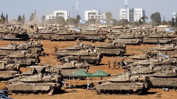 <div class="paragraphs"><p>Israeli soldiers stand next to military vehicles, amid the ongoing conflict between Israel and the Palestinian Islamist group Hamas, near the Israel-Gaza Border, in southern Israel.</p></div>