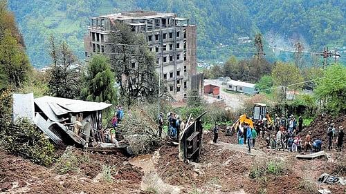 <div class="paragraphs"><p>Debris lie near a residential area after a landslide triggered by heavy rainfall, in Mizoram</p></div>