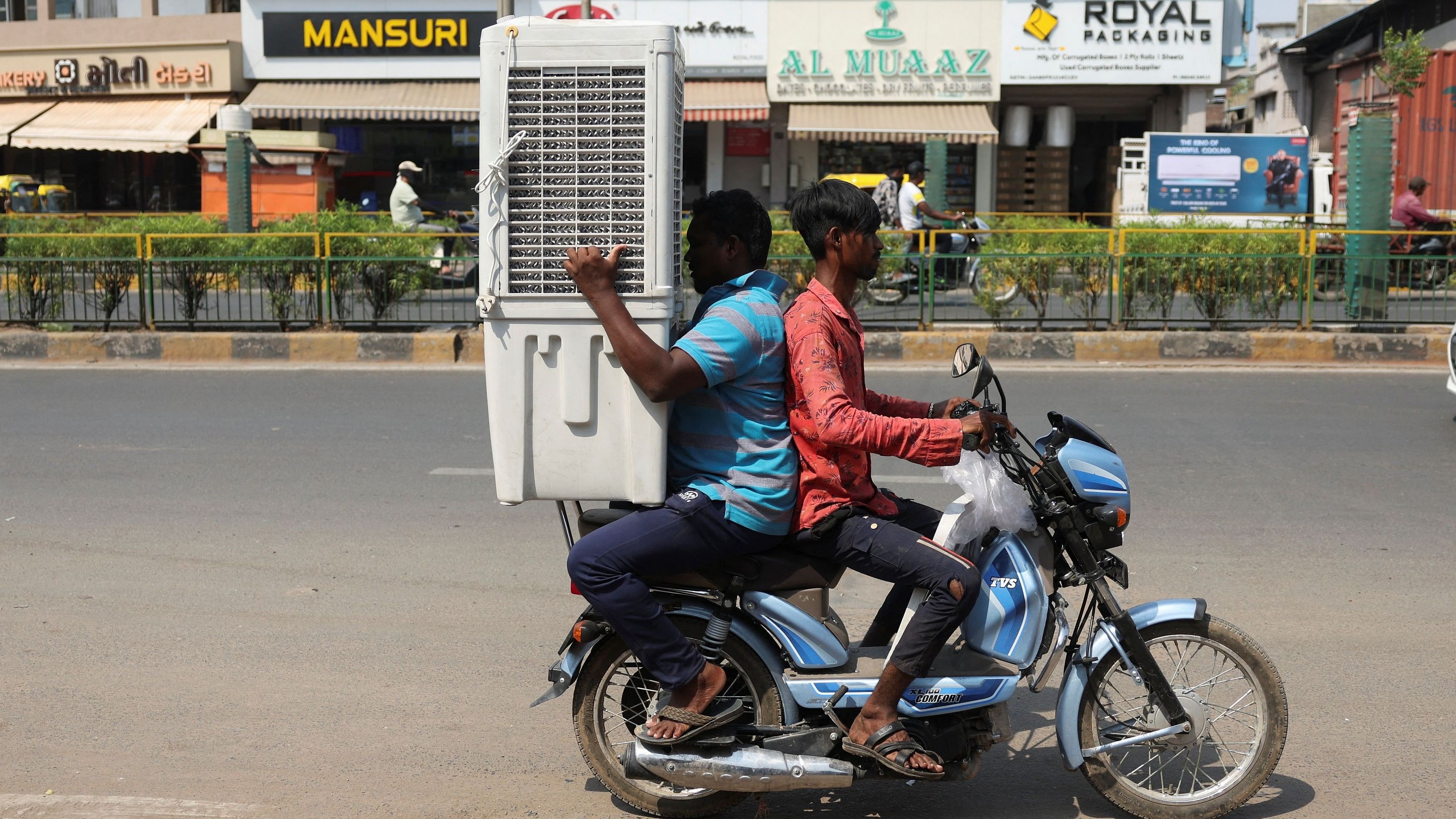 <div class="paragraphs"><p>Men transport an air cooler on a two wheeler during a hot summer day in Ahmedabad.</p></div>