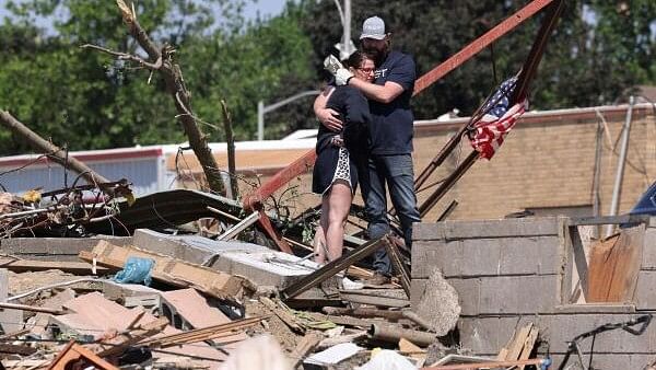 <div class="paragraphs"><p>Phillip and Kimberly Ergish embrace as they look at the remnants of their home the day after a deadly tornado struck Greenfield, Iowa, U.S. May 22, 2024.</p></div>