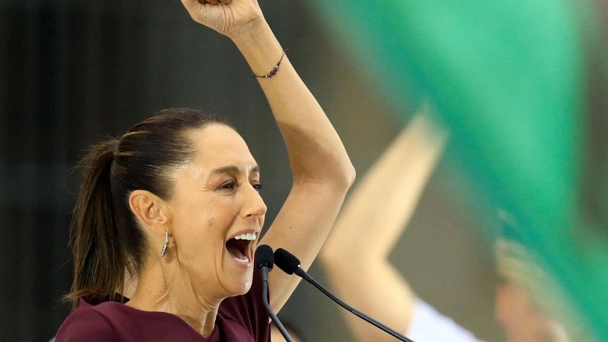 <div class="paragraphs"><p>Presidential candidate of the ruling MORENA party Claudia Sheinbaum raises a fist as she delivers a speech during her closing campaign rally at Zocalo Square, in Mexico City, Mexico.</p></div>