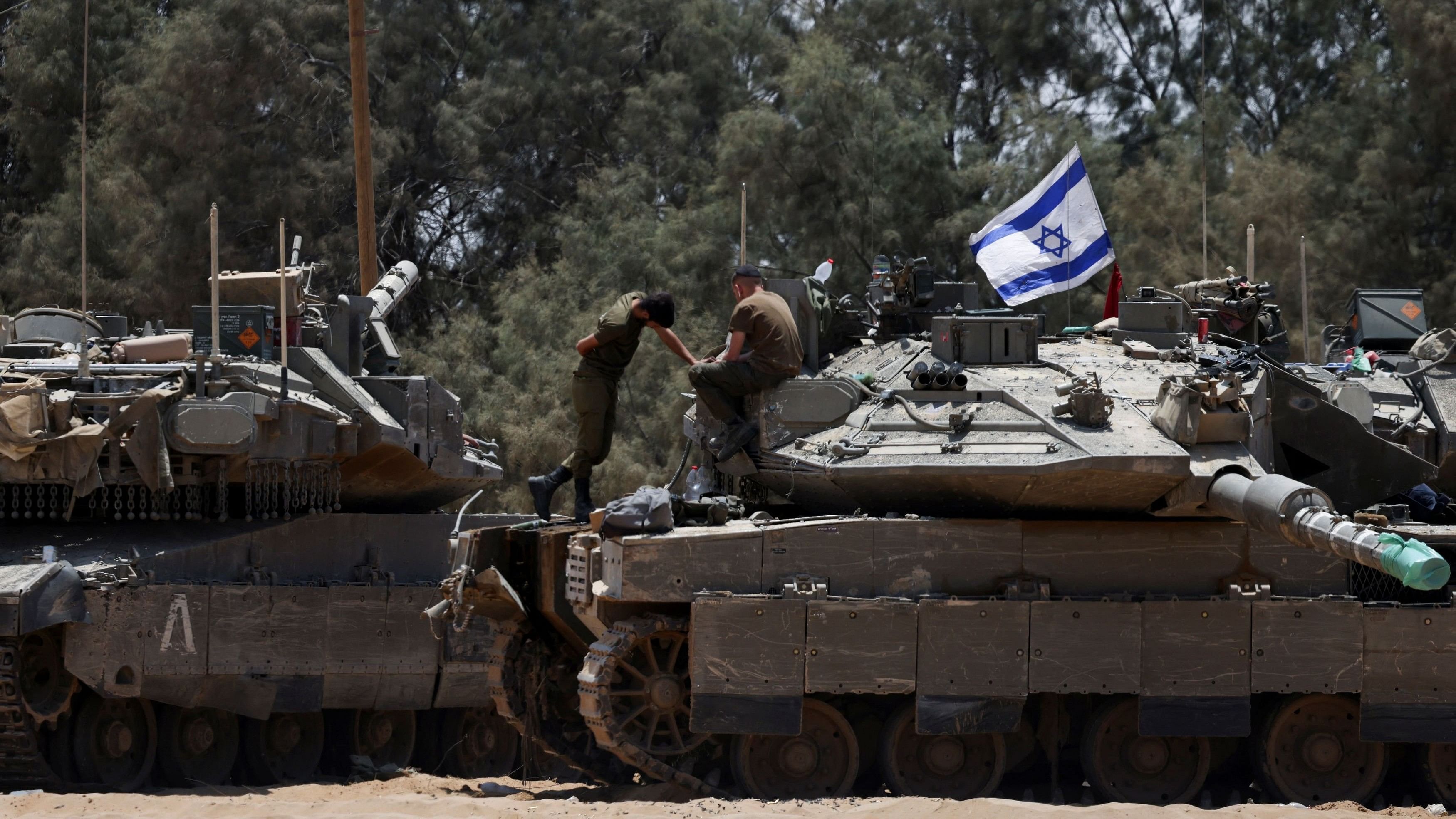 <div class="paragraphs"><p>An Israeli soldier stands on a tank, amid the ongoing conflict between Israel and the Palestinian Islamist group Hamas, near Israel's border with Gaza in southern Israel, May 29, 2024. </p></div>