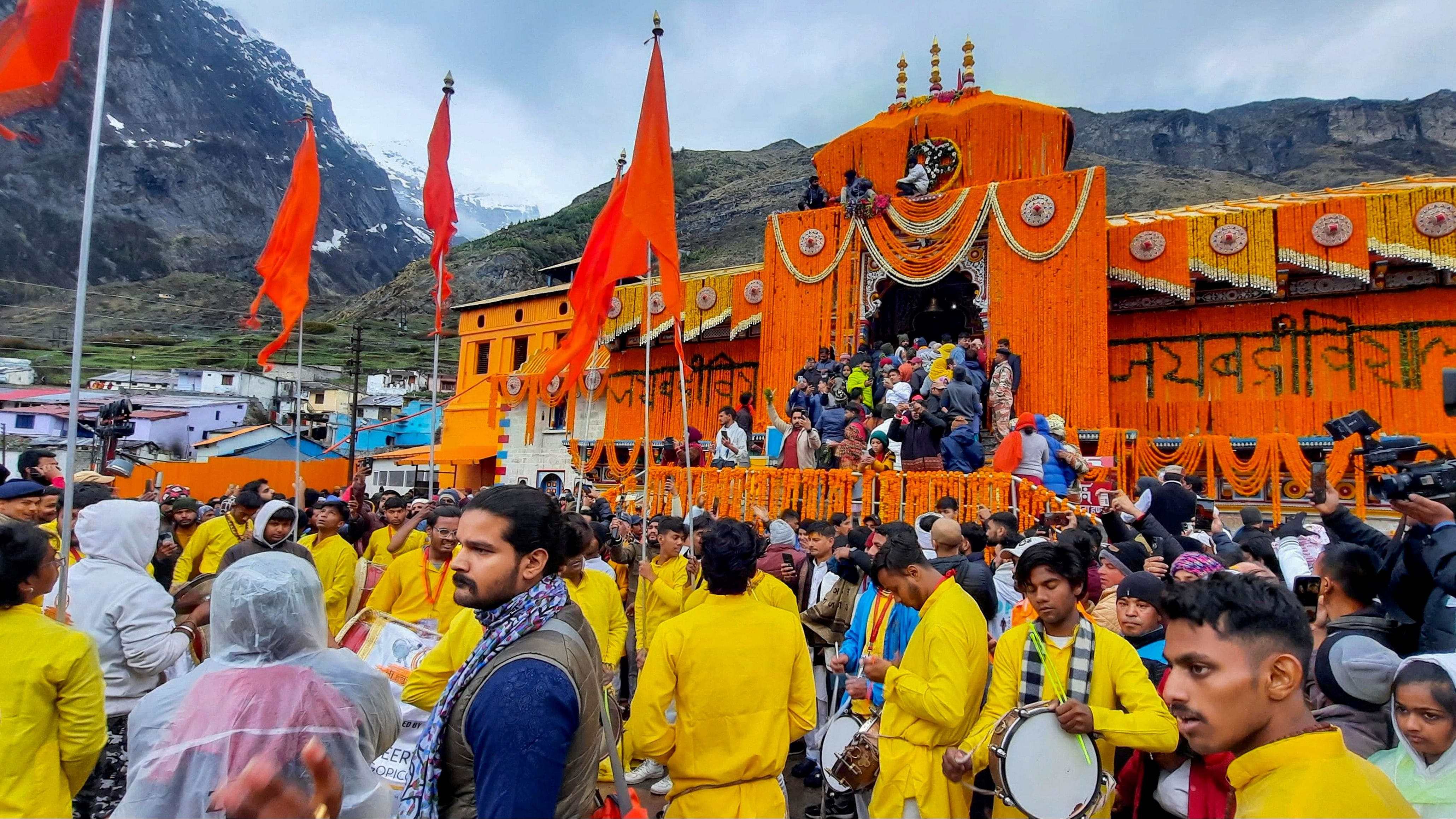 <div class="paragraphs"><p>Devotees arrive at the Shri Badrinath temple after its portals were opened, in Chamoli district, Sunday morning.</p></div>