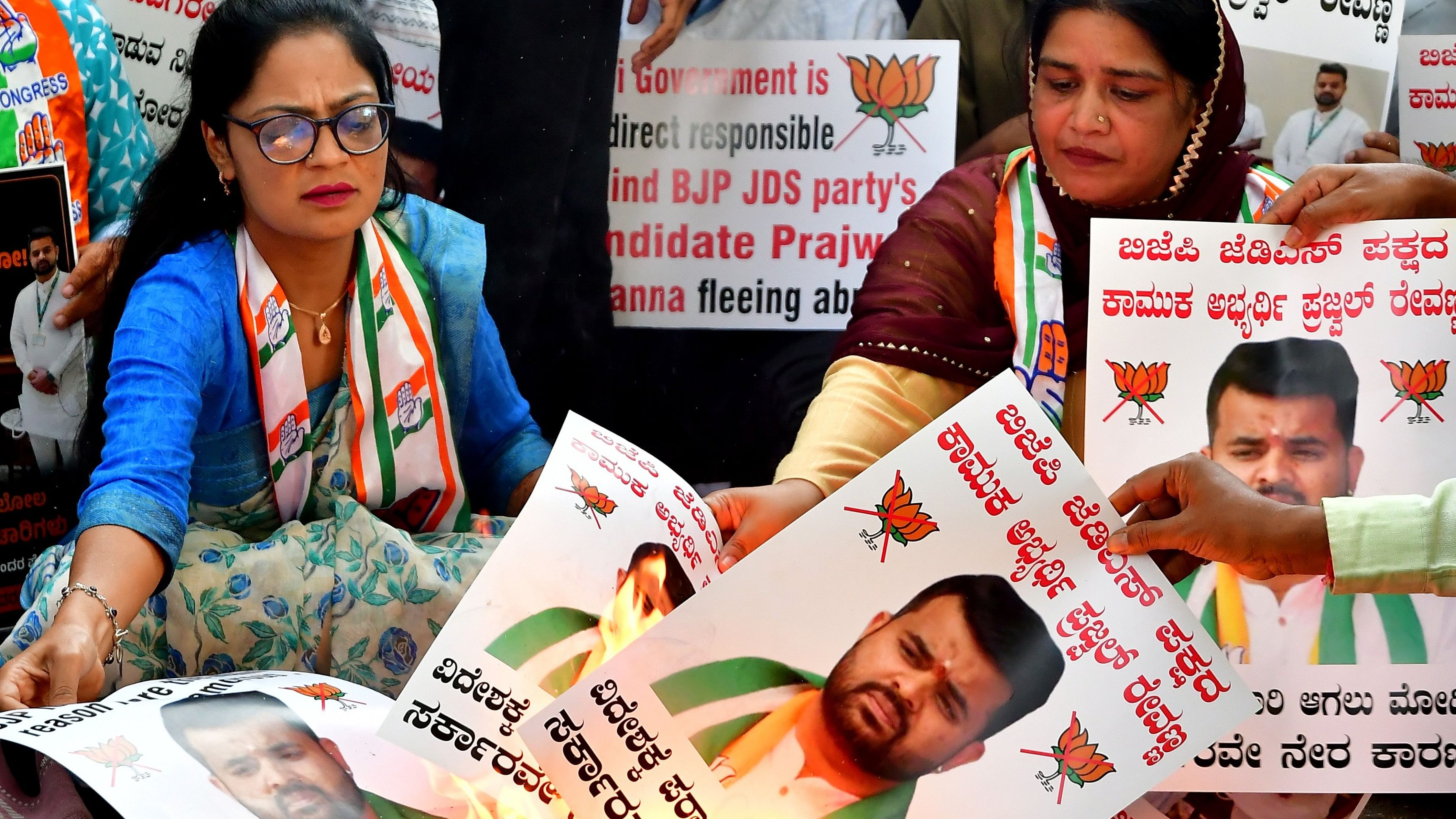 <div class="paragraphs"><p>Congress party workers stage a protest against Hassan MP Prajwal Revanna in Bengaluru on Monday.</p></div>