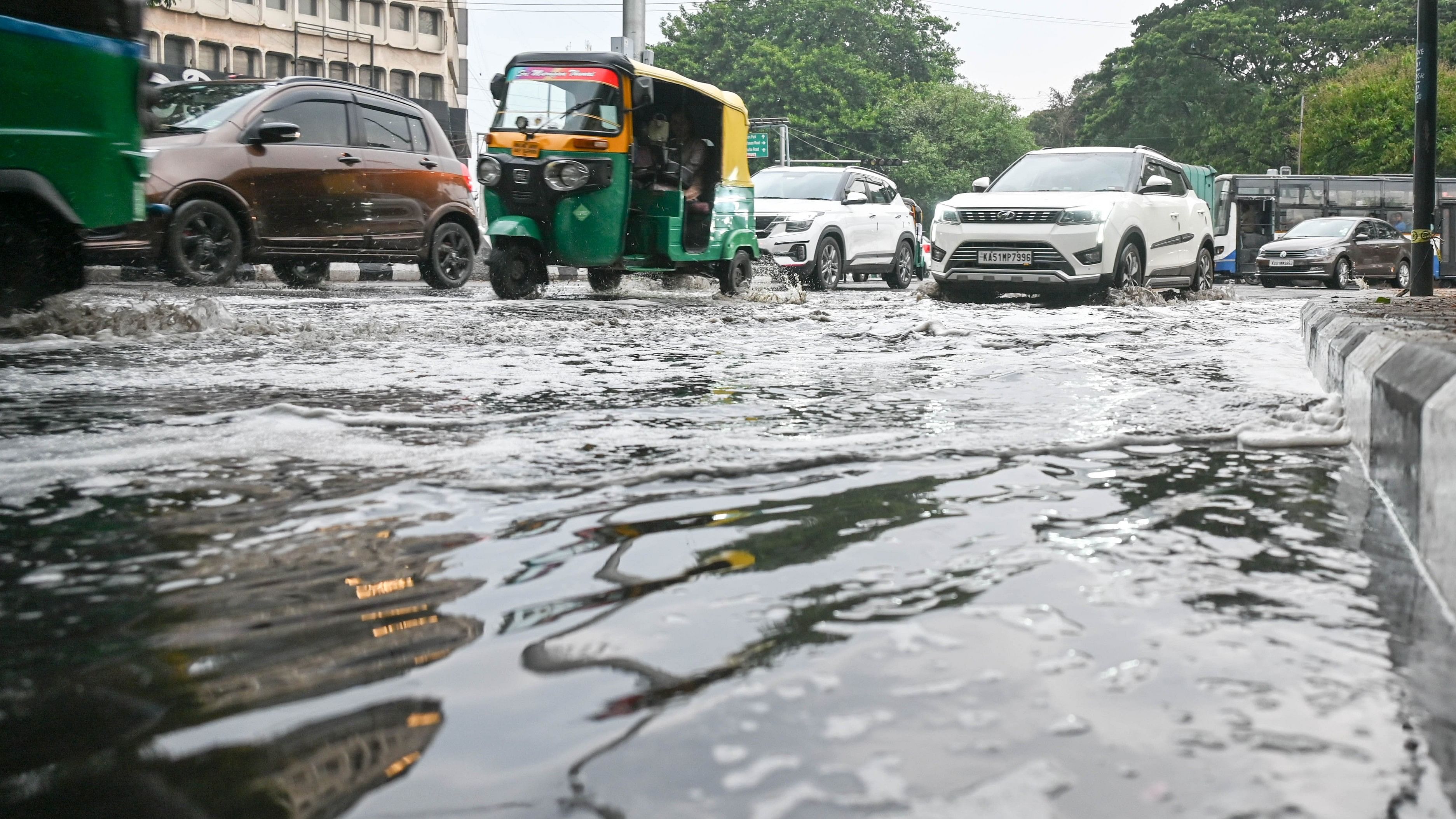 <div class="paragraphs"><p>Motorists navigate a waterlogged road after a heavy downpour in the city on Friday.&nbsp;</p></div>