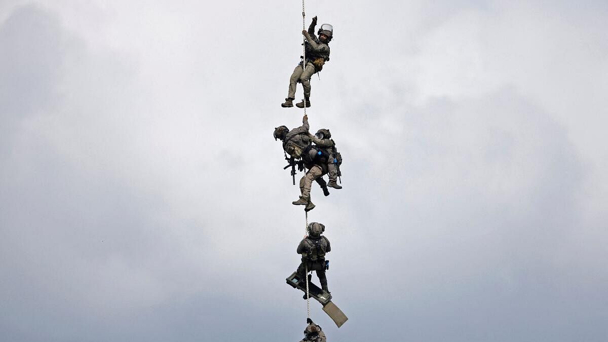 <div class="paragraphs"><p>Gendarmes of the French National Gendarmerie Intervention Group (GIGN) are lifted off by an army helicopter, as they take part in a drill, as part of their preparation for the upcoming Paris 2024 Olympic Games, near Paris.</p></div>