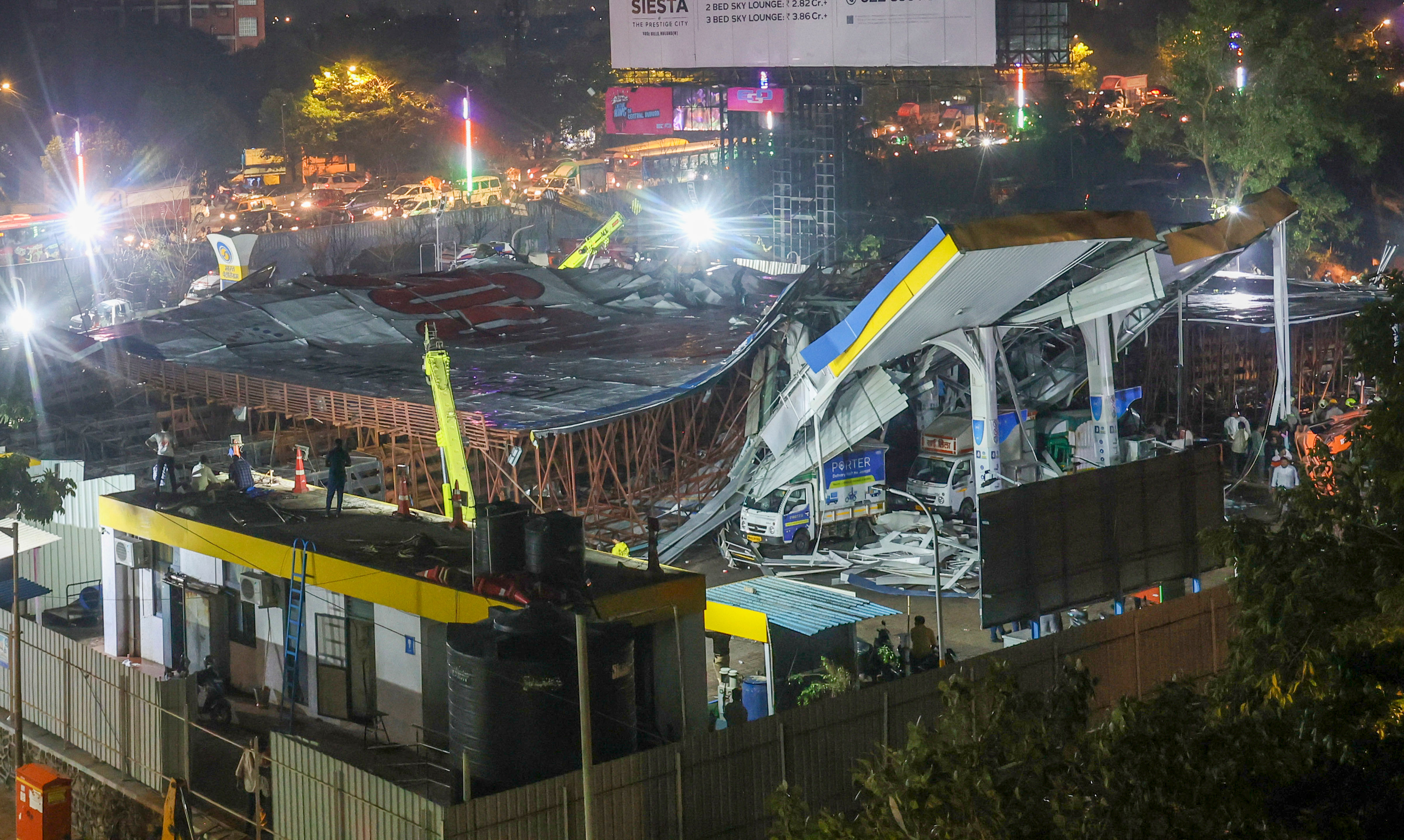 <div class="paragraphs"><p>A damaged petrol pump after a huge iron hoarding collapsed on it due to strong winds and heavy rain, at Ghatkopar in Mumbai, Monday.</p></div>