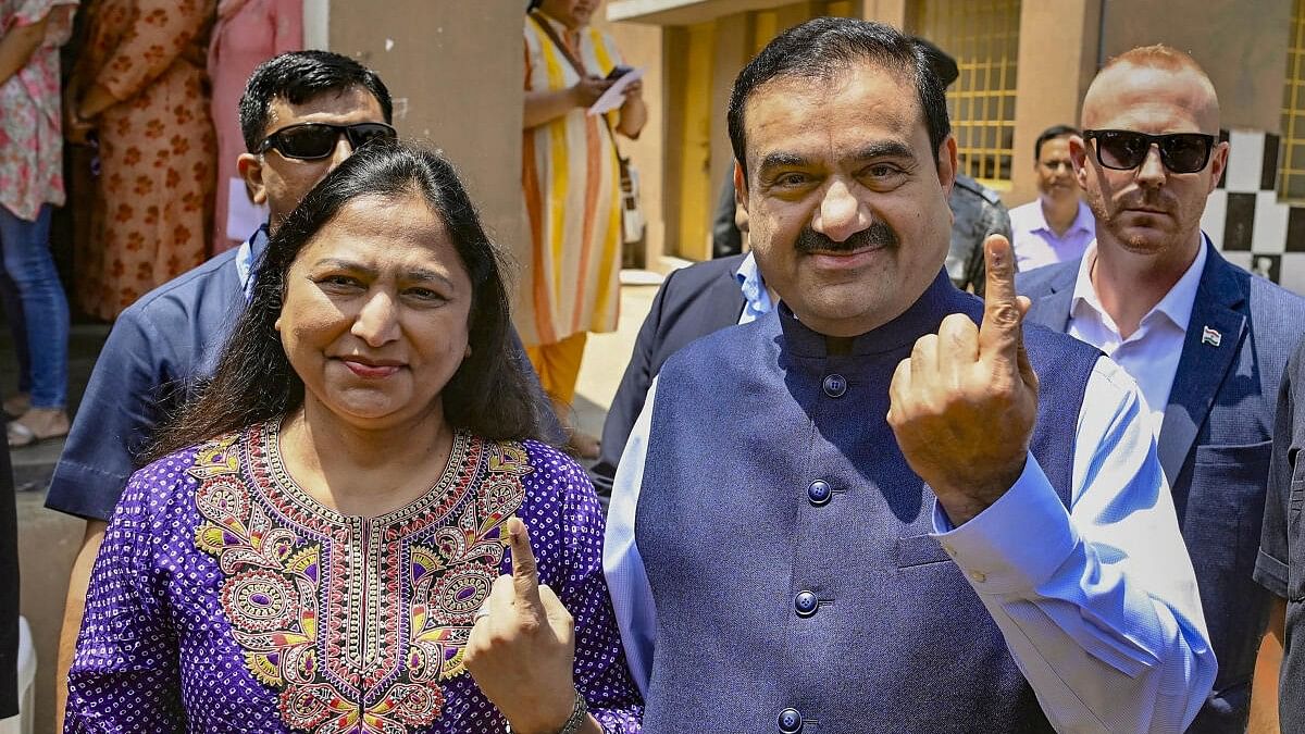 <div class="paragraphs"><p>Adani Group Chairman Gautam Adani and his wife Priti Adani show their inked fingers after casting votes at a polling booth, during the 3rd phase of Lok Sabha polls, in Ahmedabad, Tuesday, May 7, 2024.</p></div>