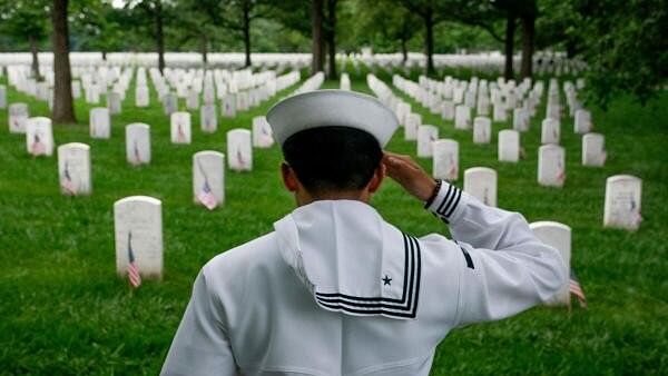 <div class="paragraphs"><p>Carlos Lorenzo Tingson, Naval Petty officer 2nd Class, visits the gravesite of a family friend at Arlington National Cemetery on Memorial Day in Arlington, Virginia, U.S., May 27,</p></div>