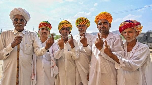 <div class="paragraphs"><p>Voters show their fingers marked with indelible ink after casting their votes for the second phase of Lok Sabha polls, in Ajmer, Friday, April 26.</p></div>