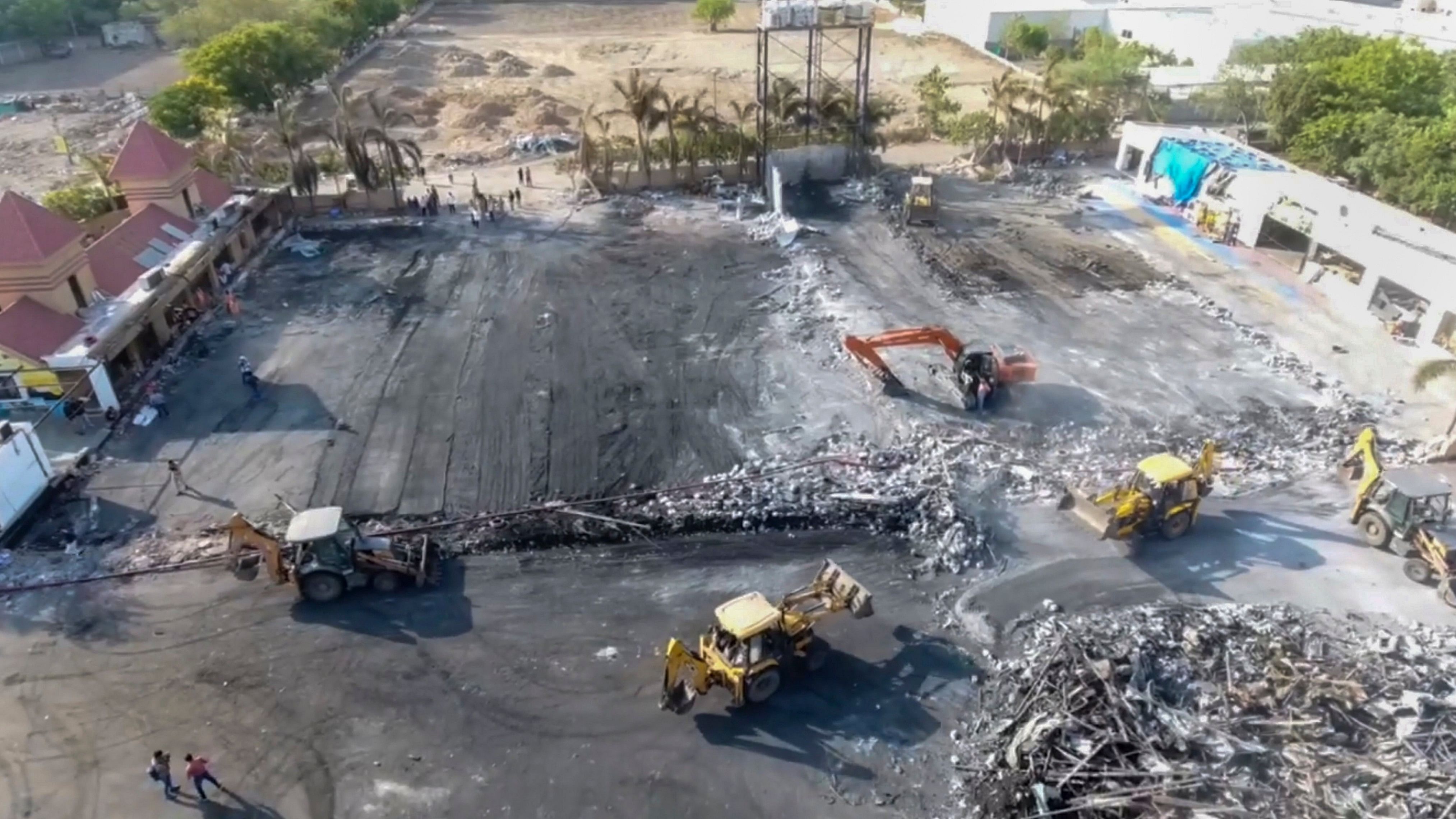 <div class="paragraphs"><p>Debris being removed from the game zone site where a fire broke out on Saturday, in Rajkot, Monday, May 27, 2024. At least 27 people were killed in the fire, according to officials. </p></div>