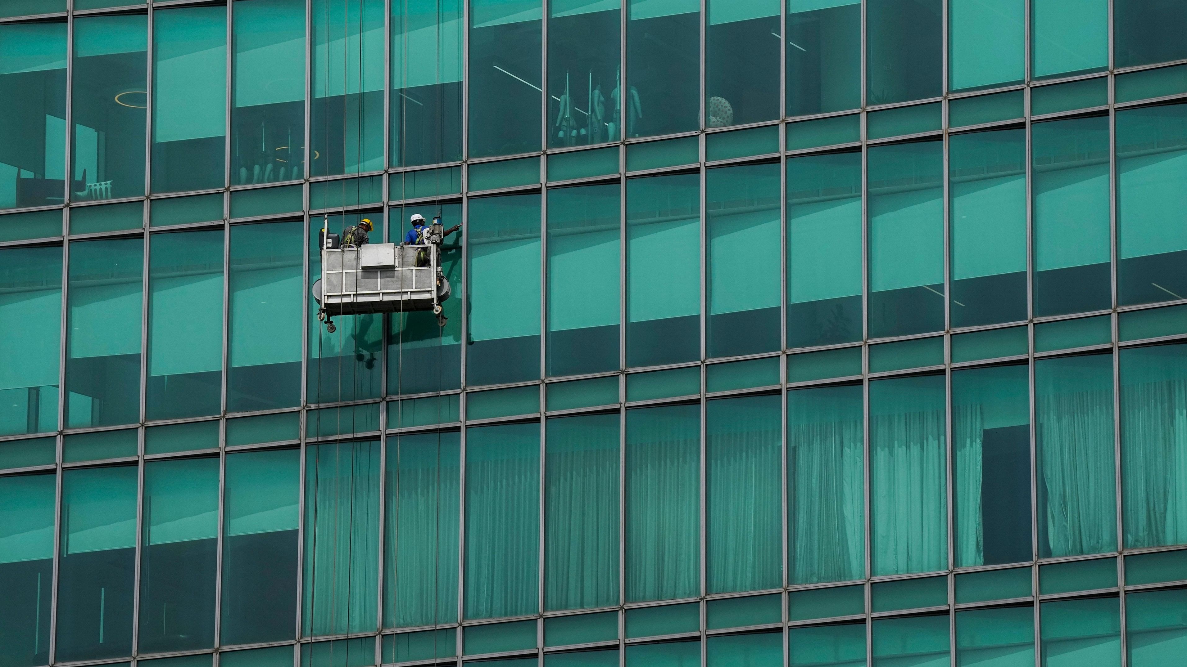 <div class="paragraphs"><p>Bengaluru: Workers clean the glass facade of a high-rise building, in Bengaluru. (Representative image)</p></div>