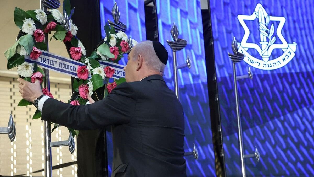 <div class="paragraphs"><p>Israeli Prime Minister Benjamin Netanyahu lays a wreath during a ceremony marking national Memorial Day for fallen soldiers of Israel's wars and victims of attacks, at Jerusalem's Mount Herzl military cemetery.</p></div>