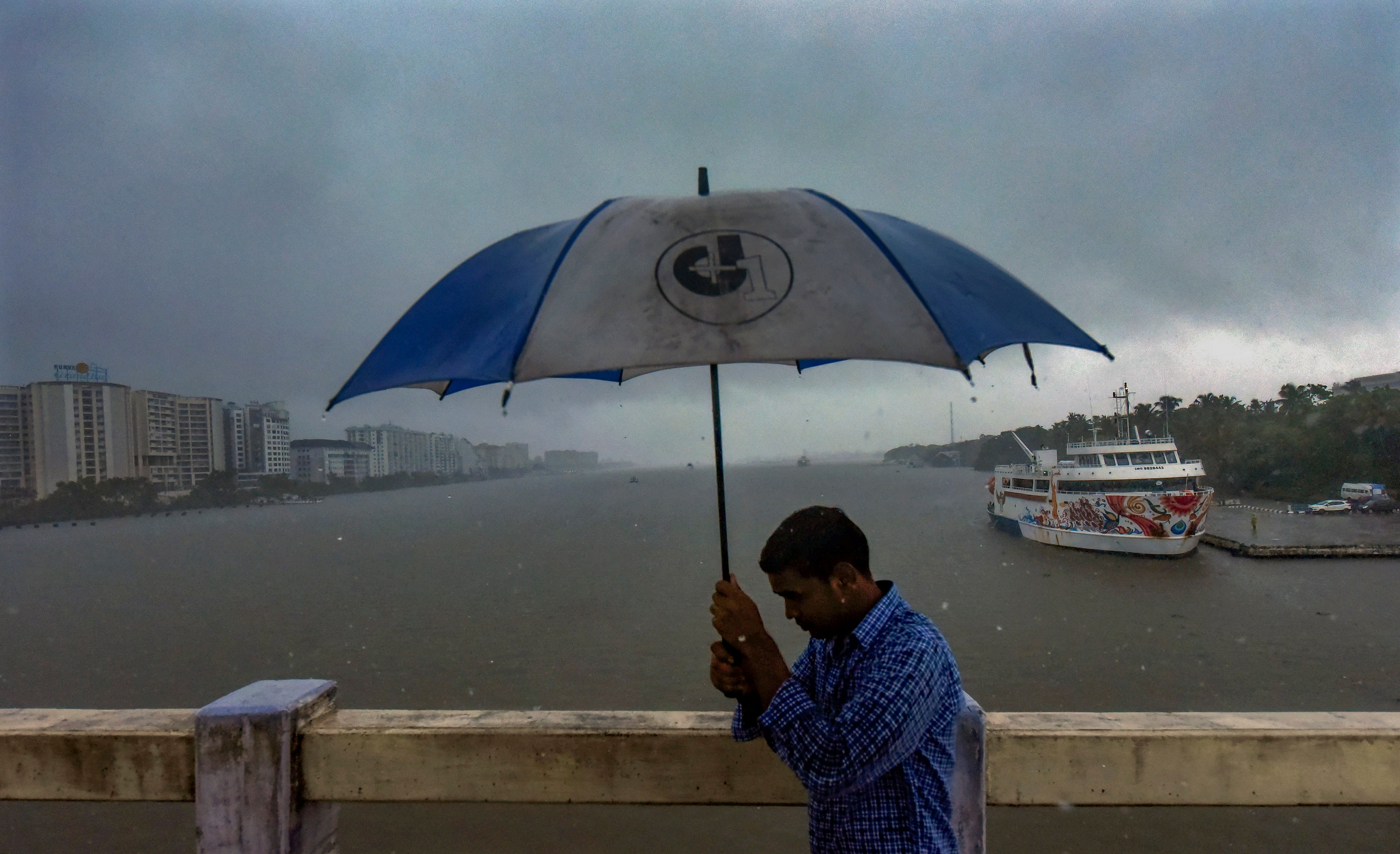 <div class="paragraphs"><p>A man holds an umbrella during rains in the backdrop of Kochi backwaters, in Kochi, Wednesday, May 29, 2024.  </p></div>