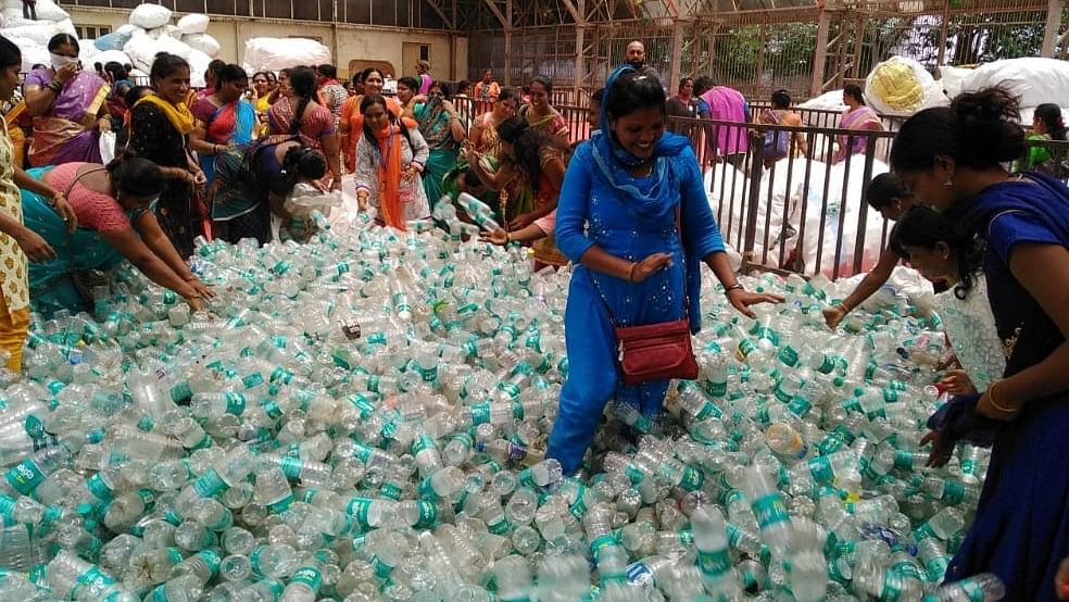 BBMP workers are seen calculating the amount of plastic waste collected during Plog Run at BBMP head office on Tuesday.