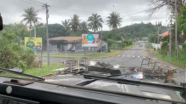 <div class="paragraphs"><p>A road is barricaded by rioters as they protest against plans to allow more people to take part in local elections in the French-ruled territory, which indigenous Kanak protesters reject, in Noumea, New Caledonia.</p></div>