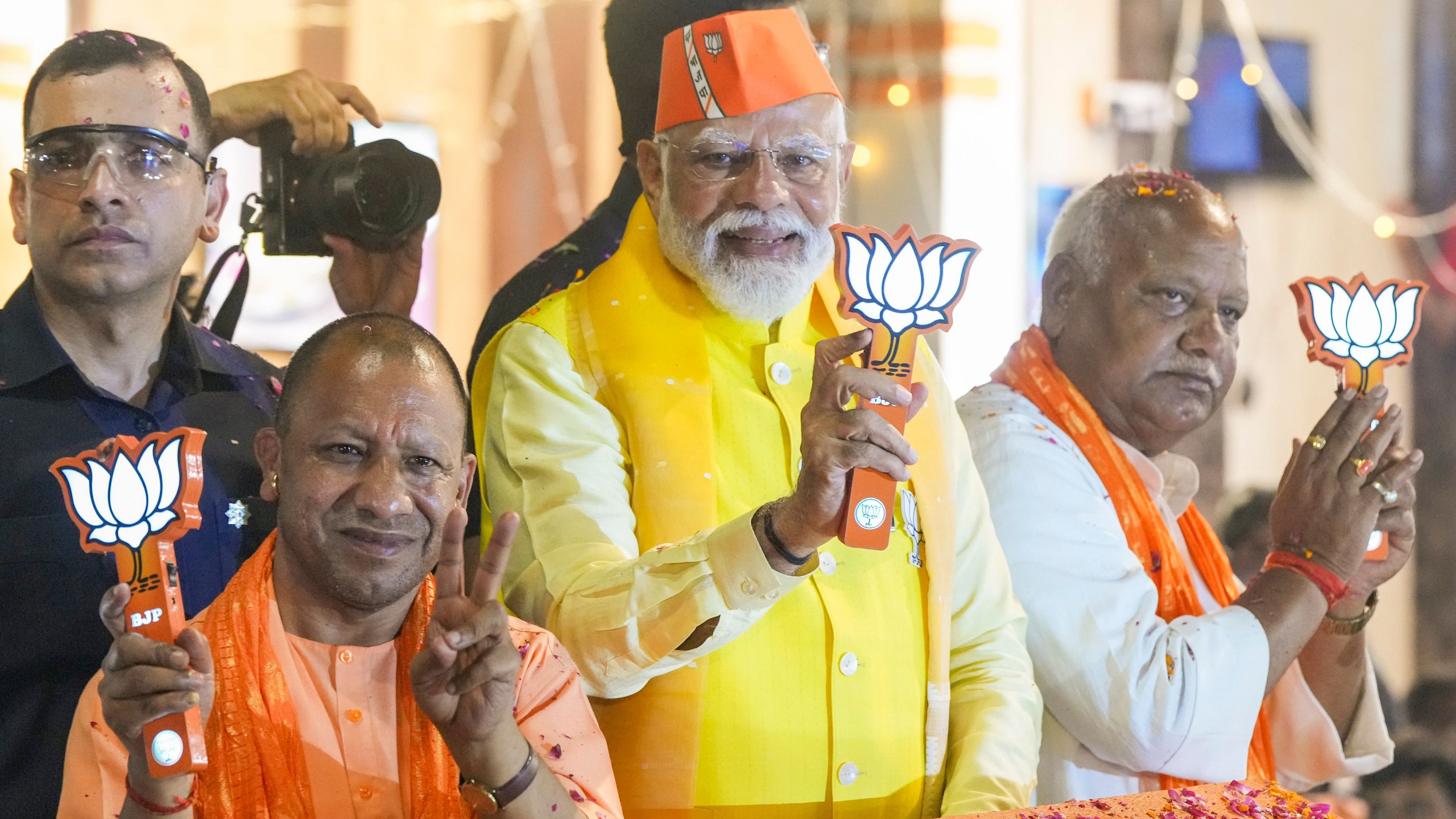 <div class="paragraphs"><p>Prime Minister Narendra Modi with Uttar Pradesh Chief Minister Yogi Adityanath and BJP candidate Lallu Singh during a roadshow for Lok Sabha elections, in Ayodhya.</p></div>