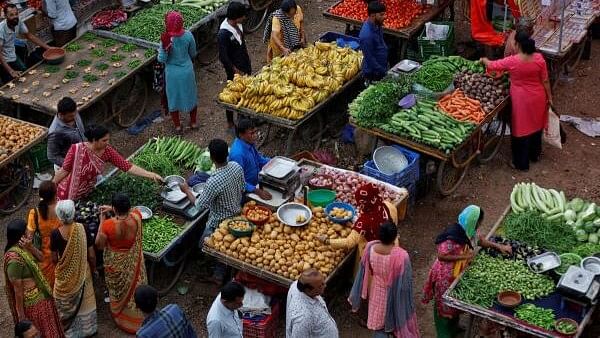 <div class="paragraphs"><p>Customers buy fruits and vegetables at an open air evening market in Ahmedabad.</p></div>