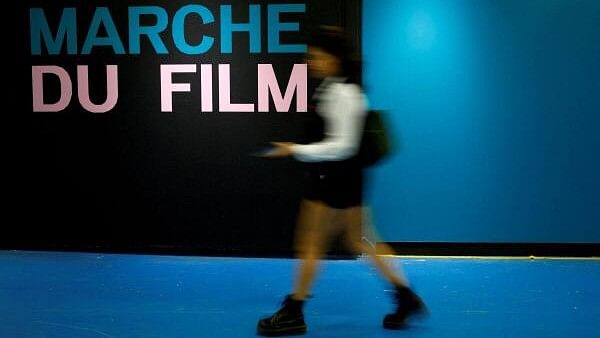 <div class="paragraphs"><p>A woman walks past the Film Market business entrance before the start of the 77th Cannes Film Festival in Cannes, France, May 13, 2024. </p></div>