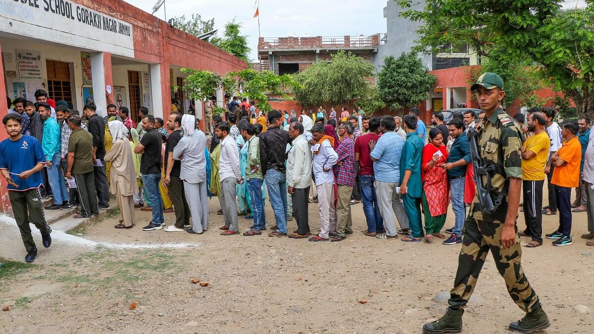 <div class="paragraphs"><p>Voters wait in a queue at a polling station to cast their votes for the 2nd phase of Lok Sabha elections, in Jammu, Friday, April 26, 2024.</p></div>