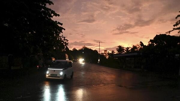 <div class="paragraphs"><p>Vehicles move on a road during sunset after rainfall, in Thiruvananthapuram, Sunday, May 12, 2024.</p></div>