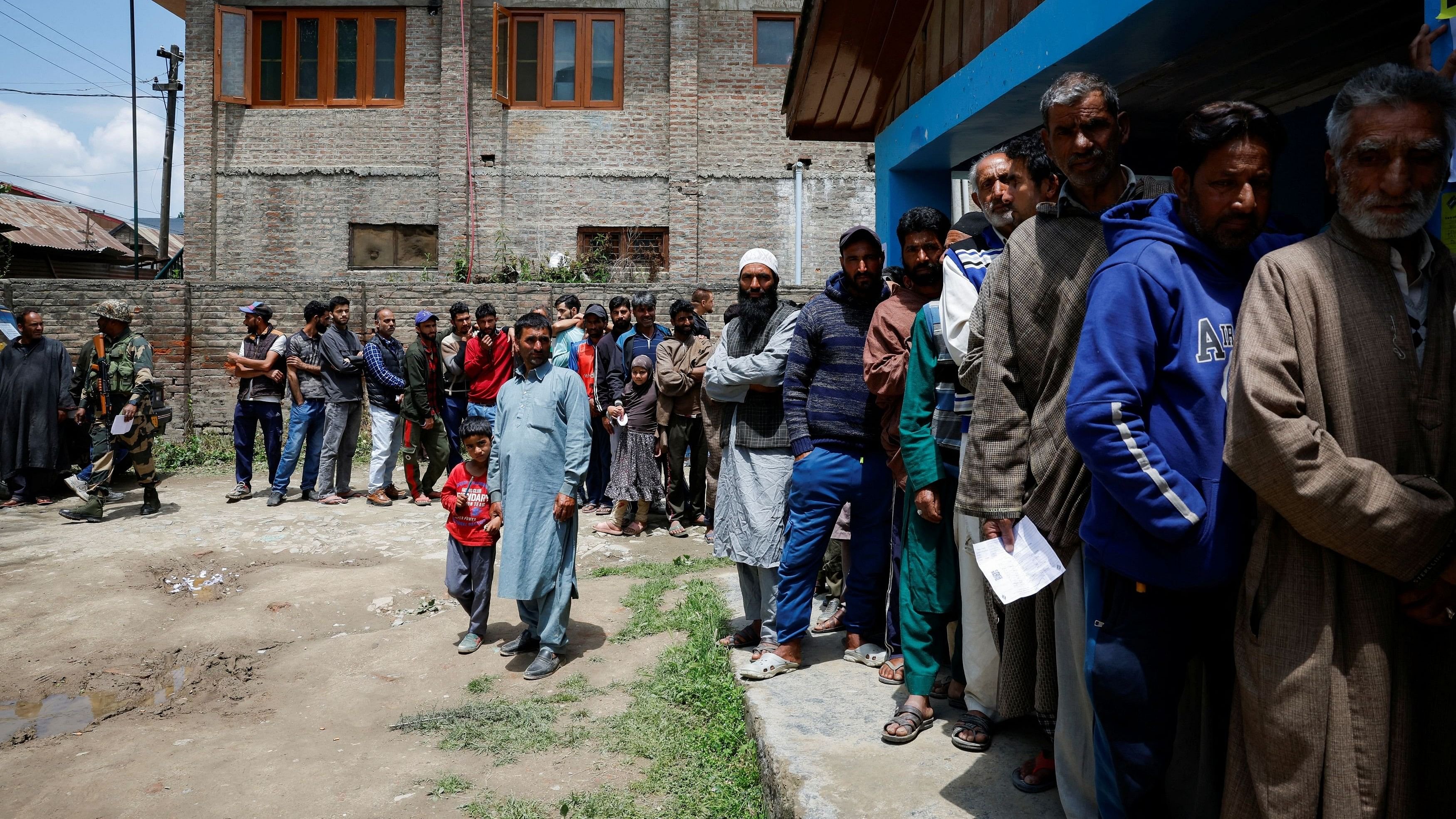 <div class="paragraphs"><p>People stand in line to vote at a polling station during the fourth general election phase, in south Kashmir's Pulwama district, May 13, 2024. </p></div>