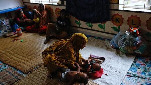 <div class="paragraphs"><p>A woman takes care of a four-day-old infant in a cyclone shelter before Cyclone Remal hits the country in the Shyamnagar area of Satkhira, Bangladesh, May 26, 2024. </p></div>