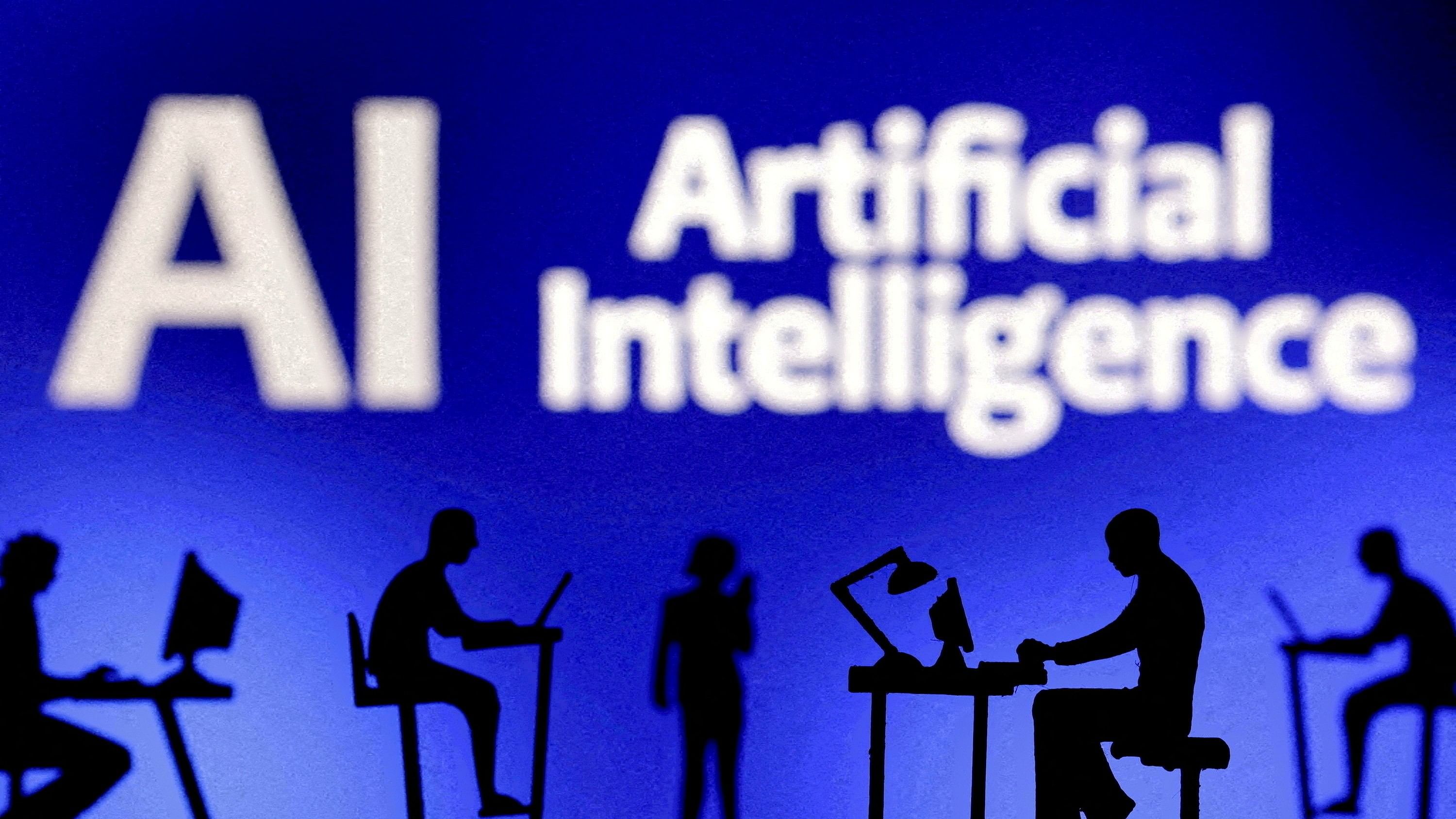 <div class="paragraphs"><p>Figurines with computers and smartphones are seen in front of the words 'Artificial Intelligence AI'.</p></div>