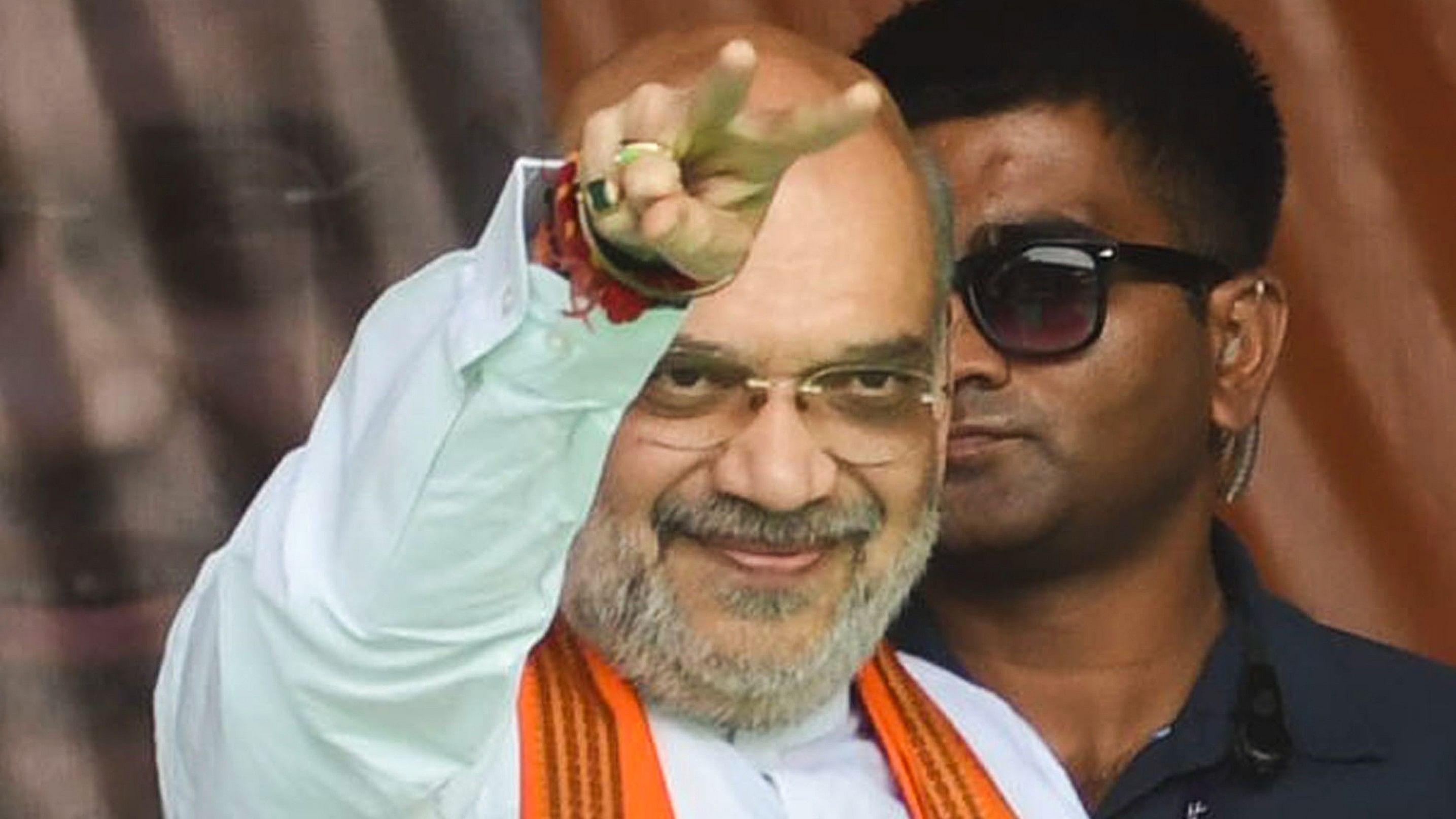 <div class="paragraphs"><p>nion Home Minister Amit Shah greets supporters during an election rally.</p></div>