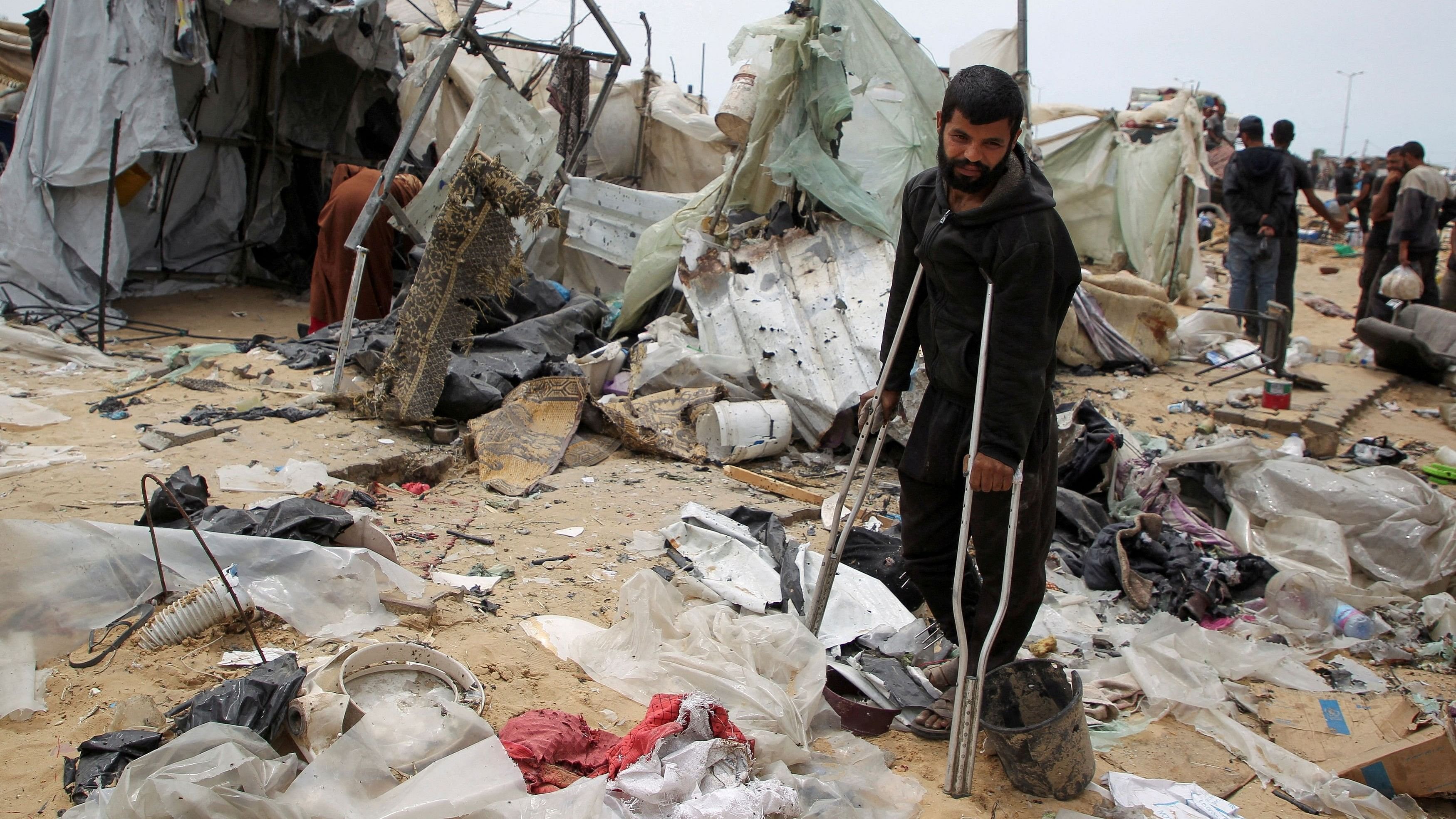 <div class="paragraphs"><p>A man looks on as Palestinians inspect a tent camp damaged in an Israeli strike during an Israeli military operation, in Rafah, in the southern Gaza Strip, May 28, 2024. </p></div>