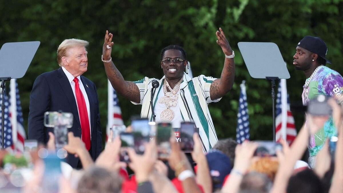 <div class="paragraphs"><p>Former US President and Republican presidential candidate Donald Trump watches as rappers Sheff G and Sleepy Hallow join him on stage at a campaign rally at Crotona Park in the Bronx borough of New York City</p></div>