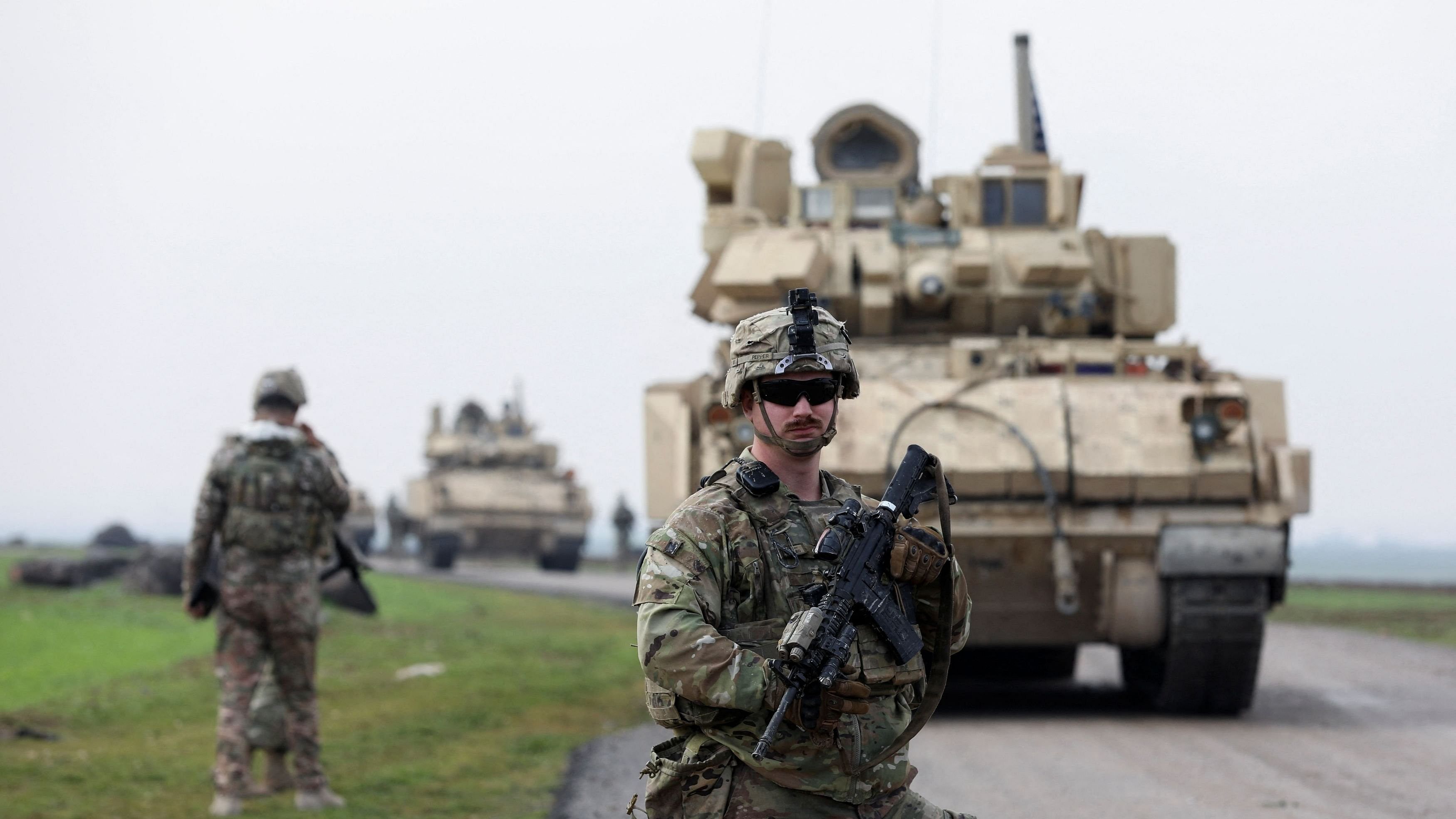 <div class="paragraphs"><p>A soldier from the US-led coalition stands guard during a joint US &amp; Kurdish-led Syrian Democratic Forces  patrol in the countryside of Qamishli in northeastern Syria.</p></div>