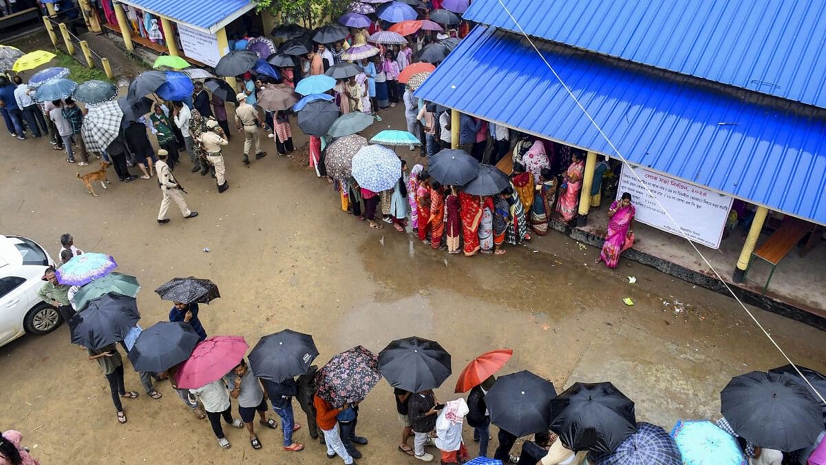 <div class="paragraphs"><p>People wait to cast their vote for the third phase of Lok Sabha elections, in Guwahati</p></div>