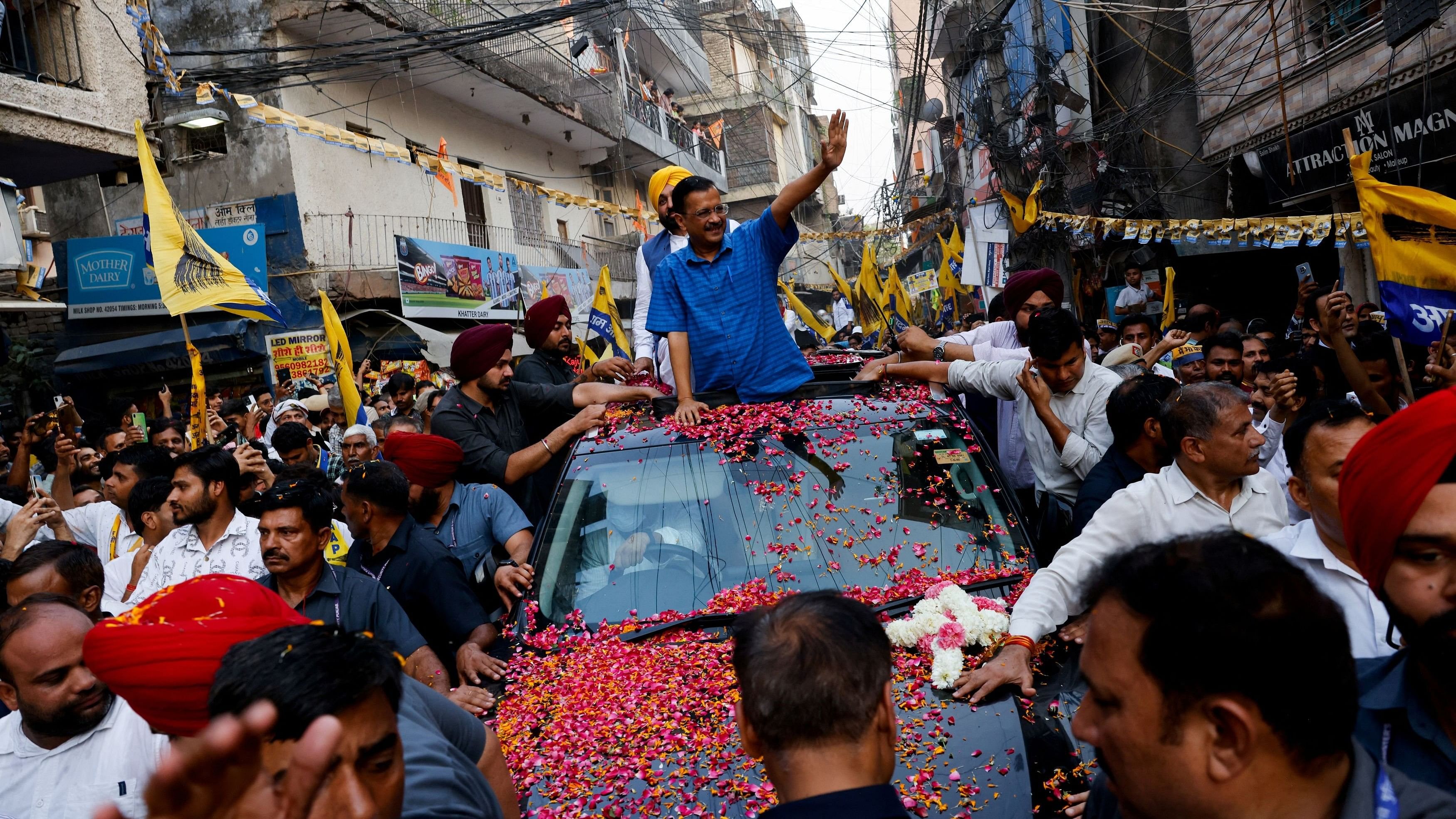 <div class="paragraphs"><p>People gather as Delhi Chief Minister Arvind Kejriwal and Chief Minister of Punjab Bhagwant Mann attend a roadshow after Supreme Court gave temporary bail to the Aam Aadmi Party's national conveyor in a liquor policy case, in New Delhi.</p></div>