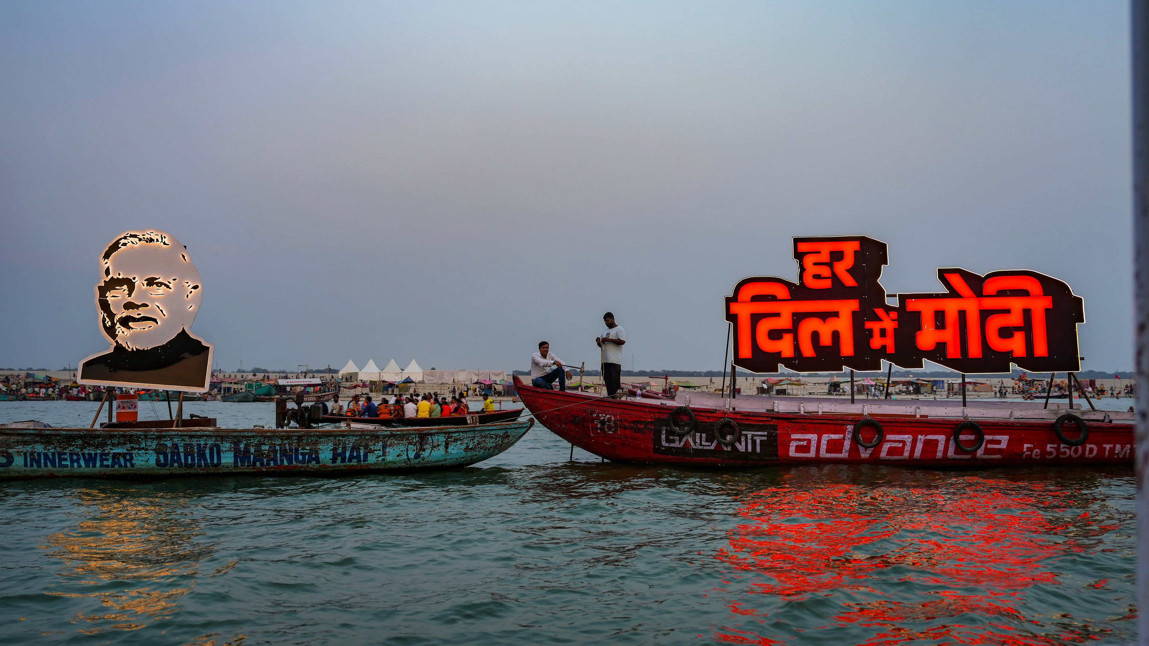 <div class="paragraphs"><p>A portrait of Prime Minister Narendra Modi is lit on a boat ahead of his roadshow for the Lok Sabha elections, in Varanasi, Sunday, May 12, 2024.</p></div>