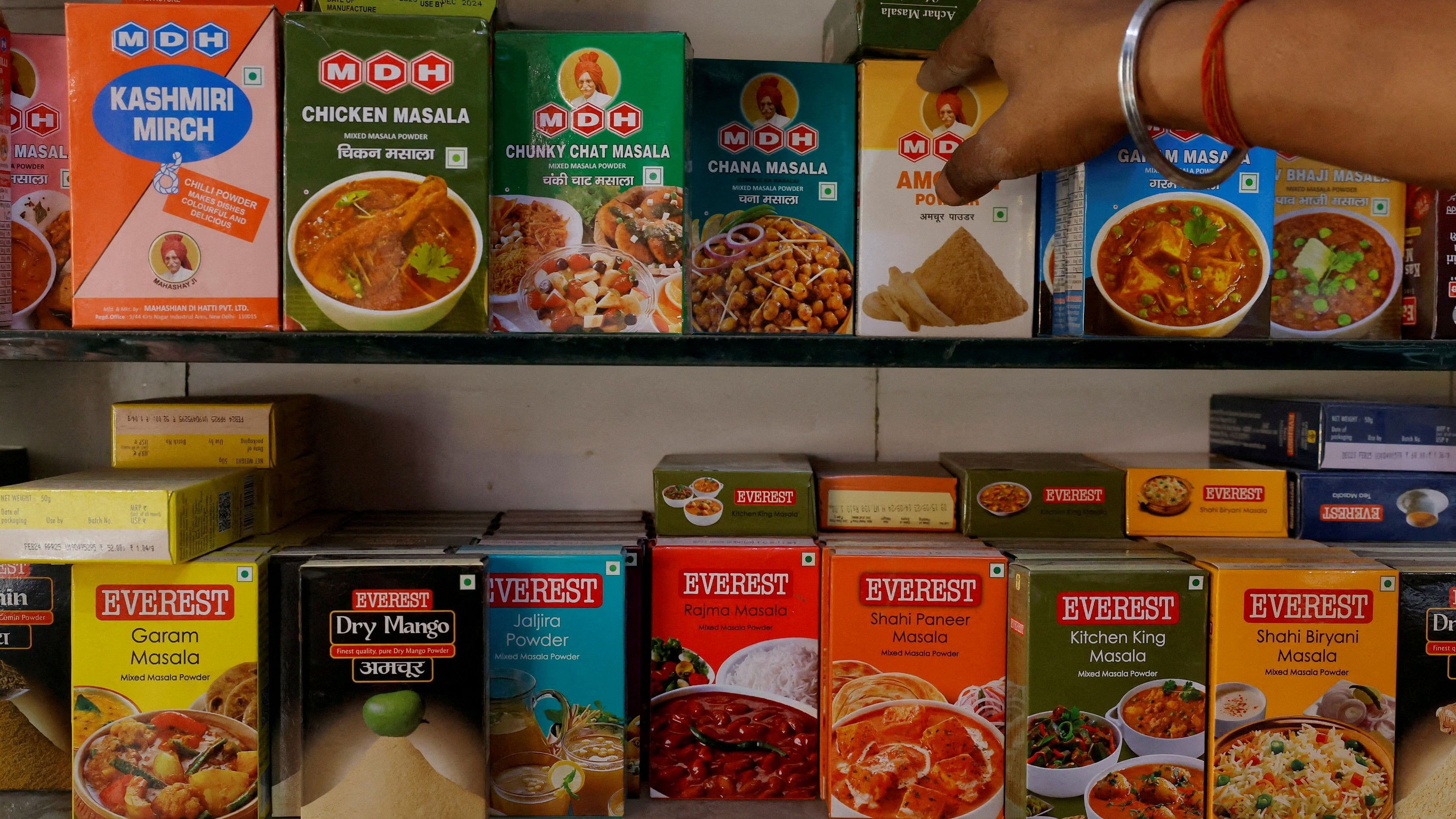 <div class="paragraphs"><p>A man adjusts the spice boxes of MDH and Everest on the shelf of a shop at a market in New Delhi, India, April 29, 2024. </p></div>