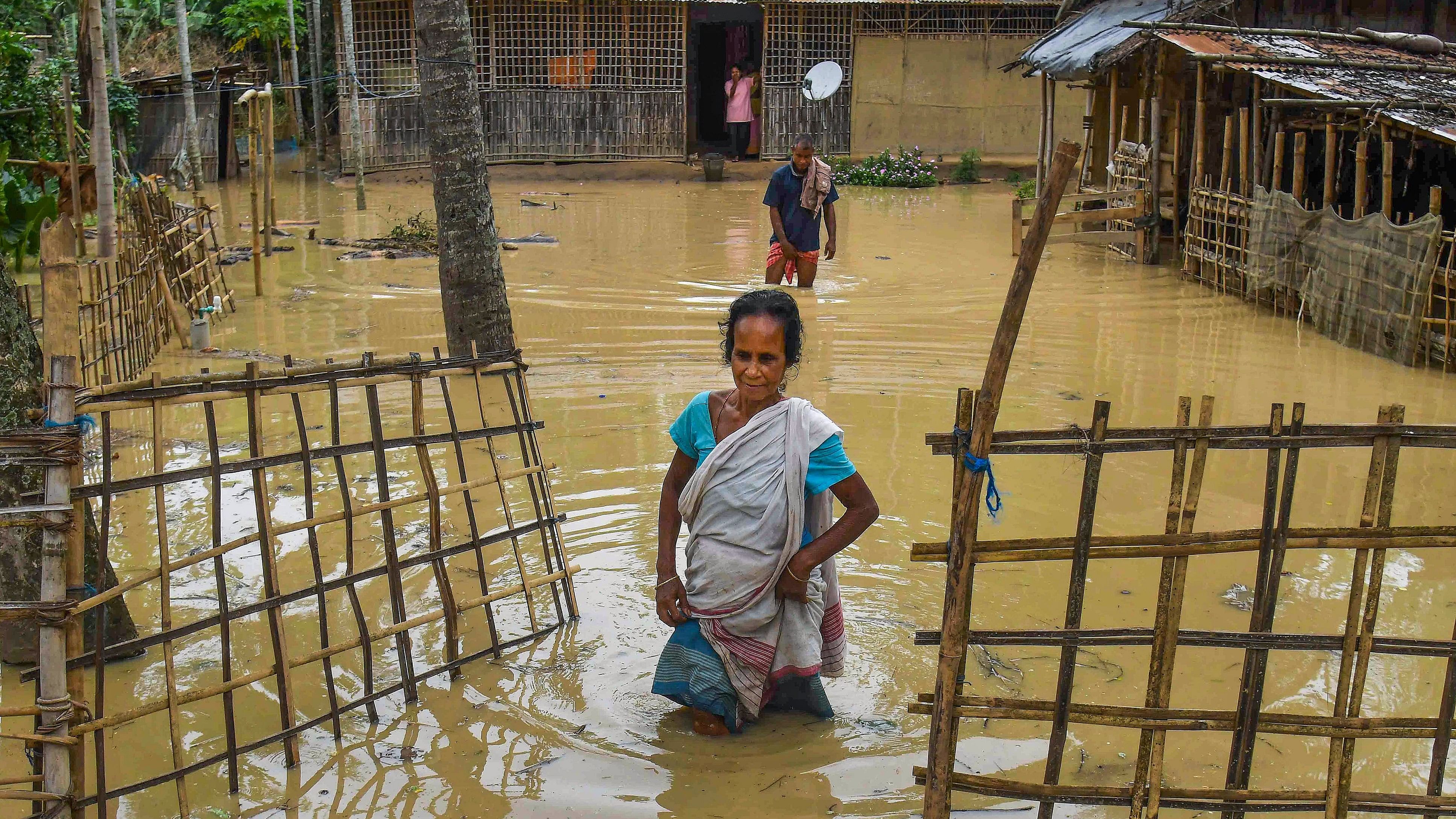 <div class="paragraphs"><p>A woman walks through a flooded area following rains, after the landfall of cyclone 'Remal', in Nagaon district of Assam.</p></div>