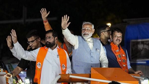 <div class="paragraphs"><p>Prime Minister Narendra Modi, Maharashtra Chief Minister Eknath Shinde and Deputy Chief Minister Devendra Fadnavis during a roadshow, for Lok Sabha polls, in Mumbai, Wednesday, May 15, 2024.</p></div>