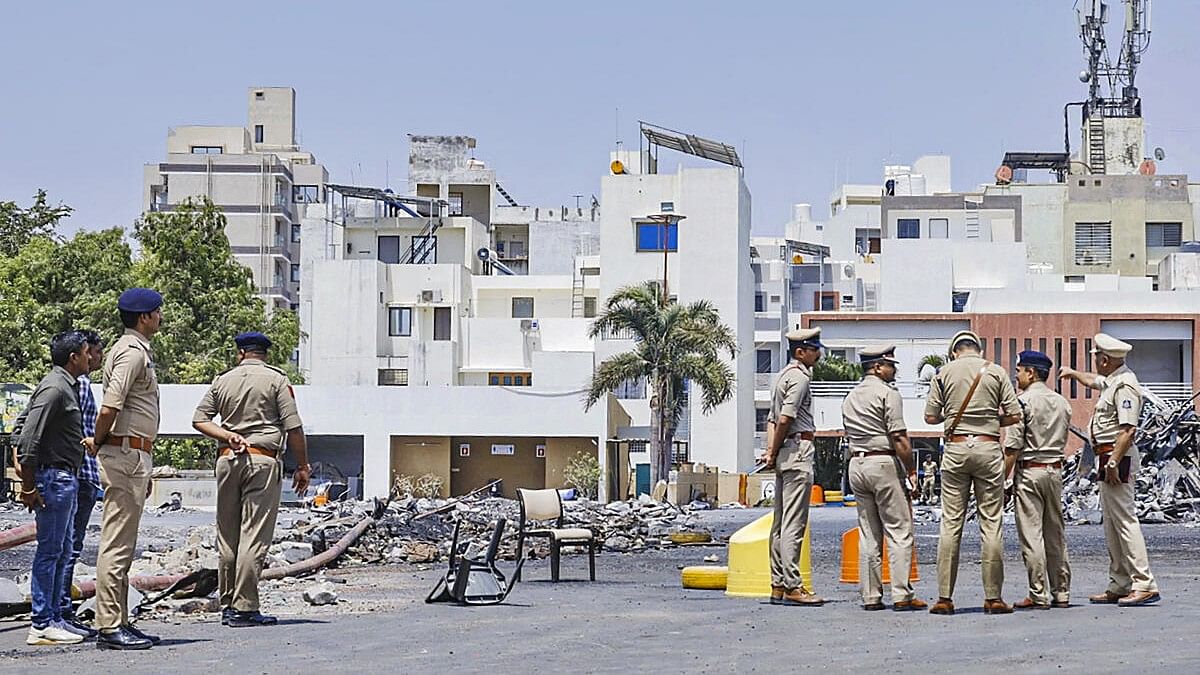 <div class="paragraphs"><p>Rajkot Commissioner of Police Brijesh Kumar Jha visits the game zone site in Rajkot.</p></div>