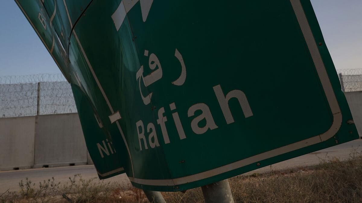 <div class="paragraphs"><p>A damaged road sign stands at the Kerem Shalom border crossing, as military operations continue in the southern Gaza city of Rafah</p></div>