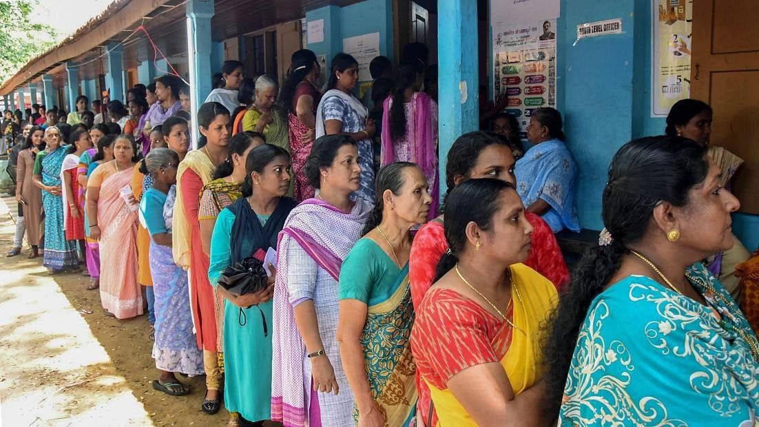 Voters queue up to cast their votes at a polling station, during the third phase of the 2019 Lok Sabha polls, in Kochi, Tuesday, April 23, 2019. (PTI Photo)