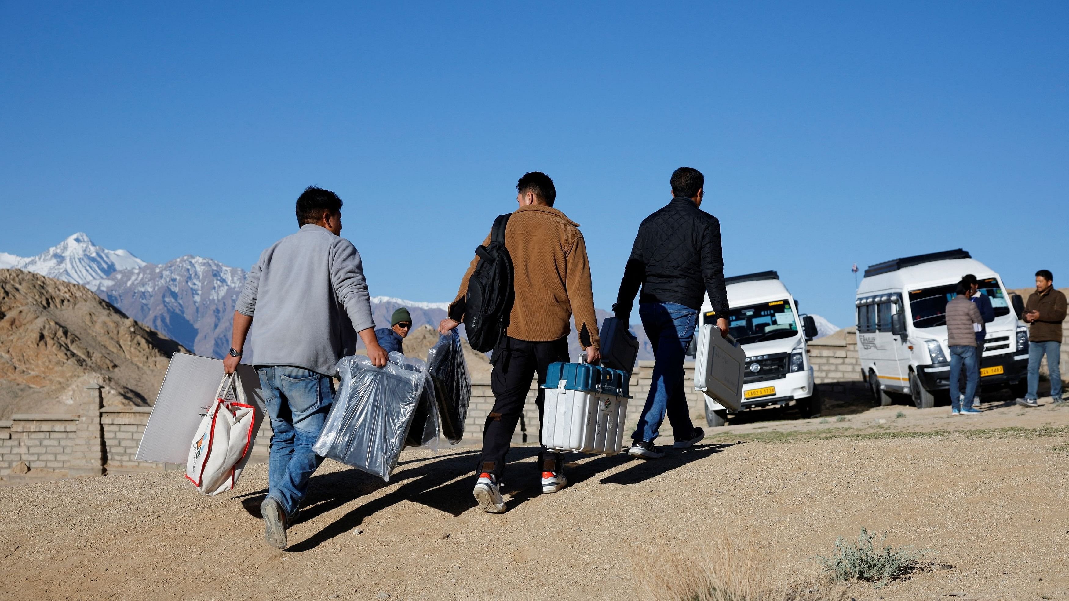 <div class="paragraphs"><p>Polling officials walk towards their designated vehicle after collecting election materials at a distribution centre, ahead of the fifth phase of the general elections, in Ladakh, May 18, 2024. </p></div>