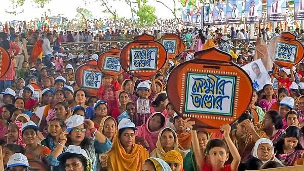 <div class="paragraphs"><p>Women supporters hold placards during a public meeting at Rampurhat virtually addressed by TMC National General Secretary Abhishek Banerjee for the Lok Sabha elections, in Birbhum district.</p></div>